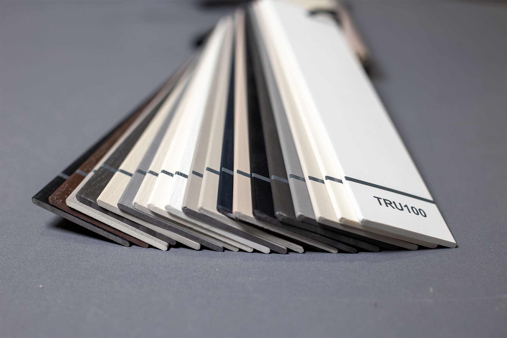 Two people sit across a table in a stylish room with red velvet walls and a large red pendant light. The mood is intimate and modern.