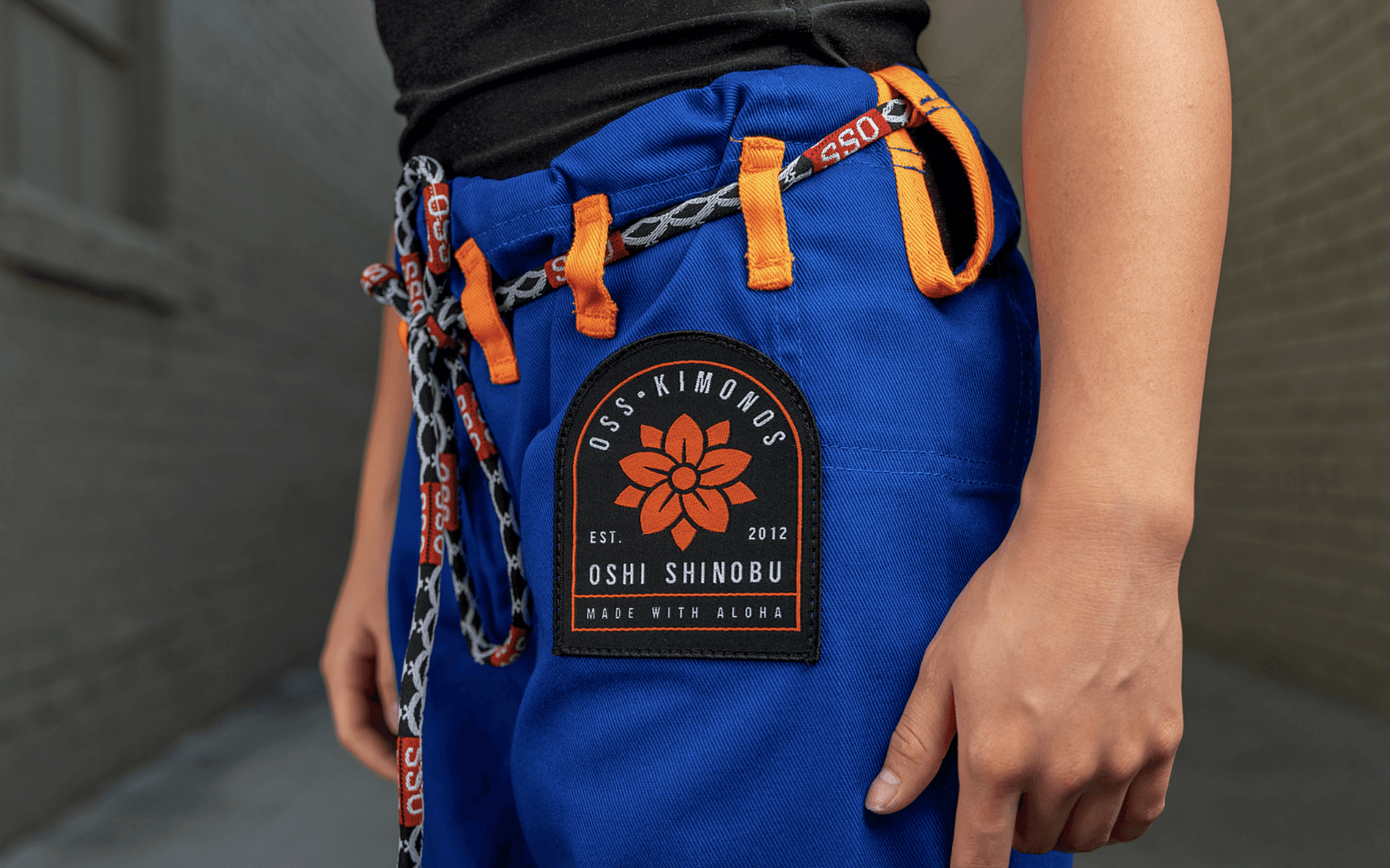 Person in dark clothing standing in moody, atmospheric lighting