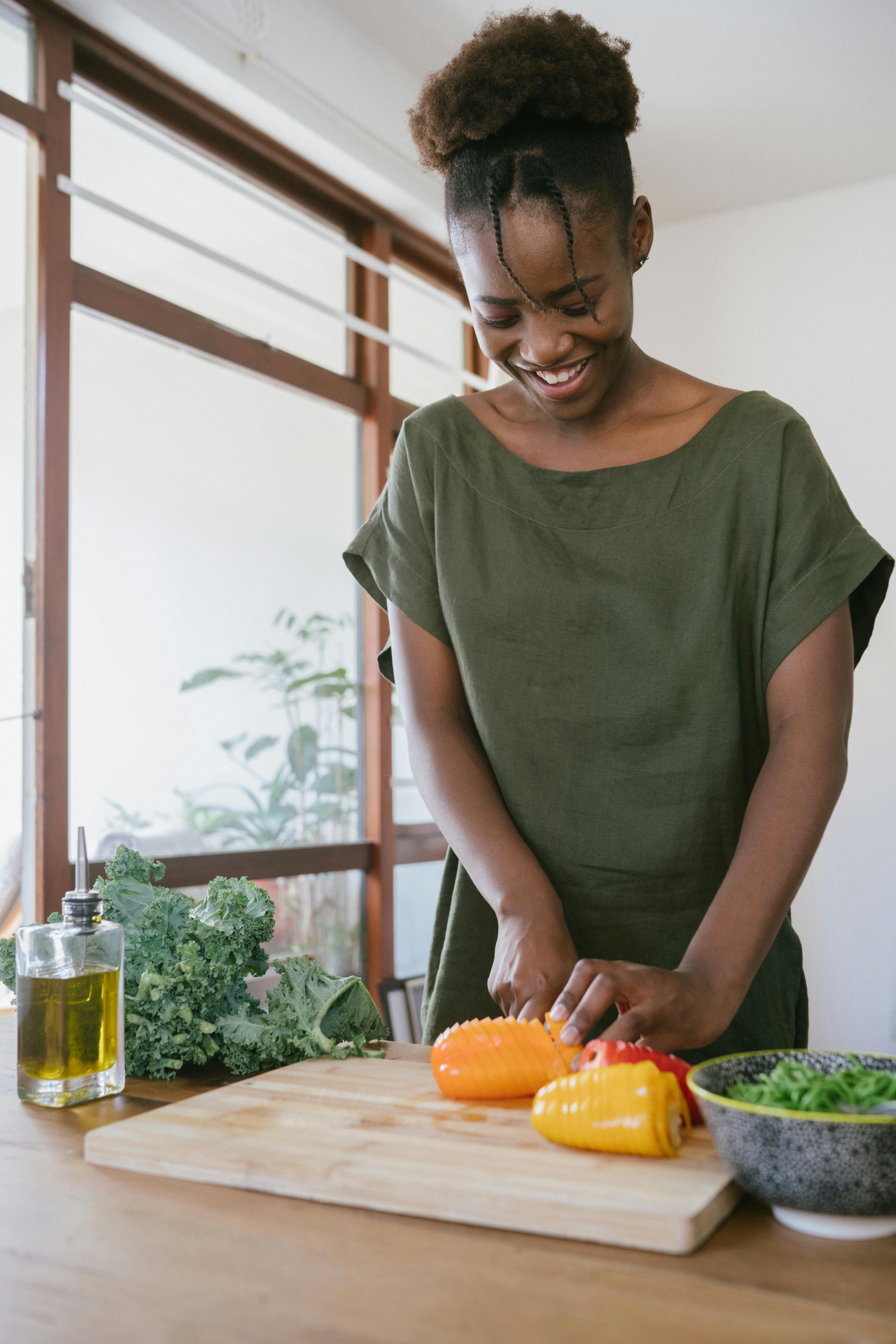 Carer preparing healthy meals for elderly client in home kitchen.