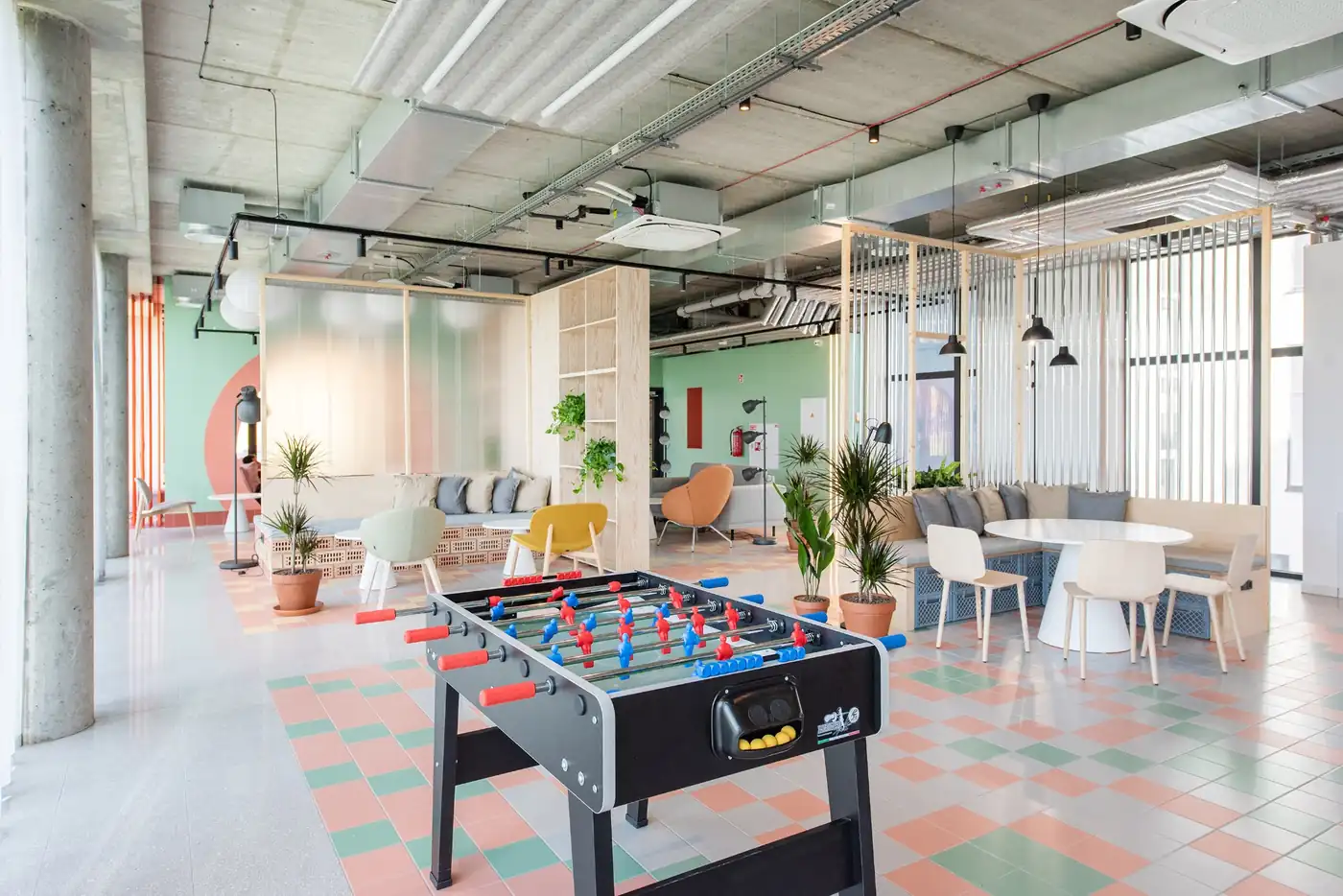 Games and social area in Vilnius student accommodation with table football and communal seating.