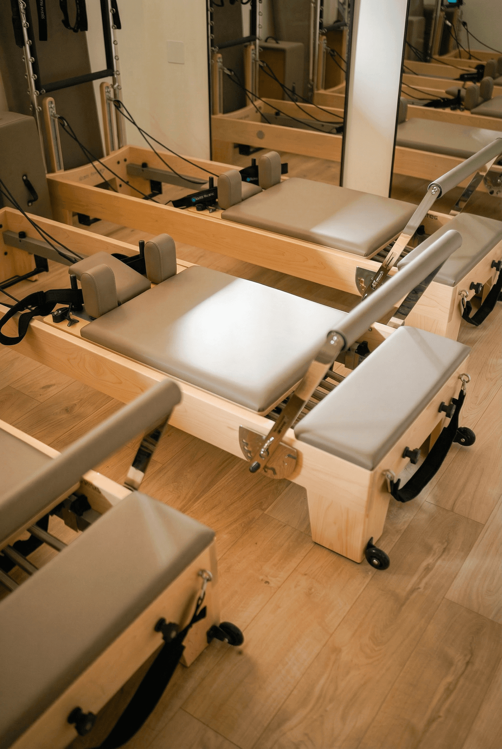 A serene spa setting with two lounge chairs beside a warm, reflective pool and soft, natural lighting.