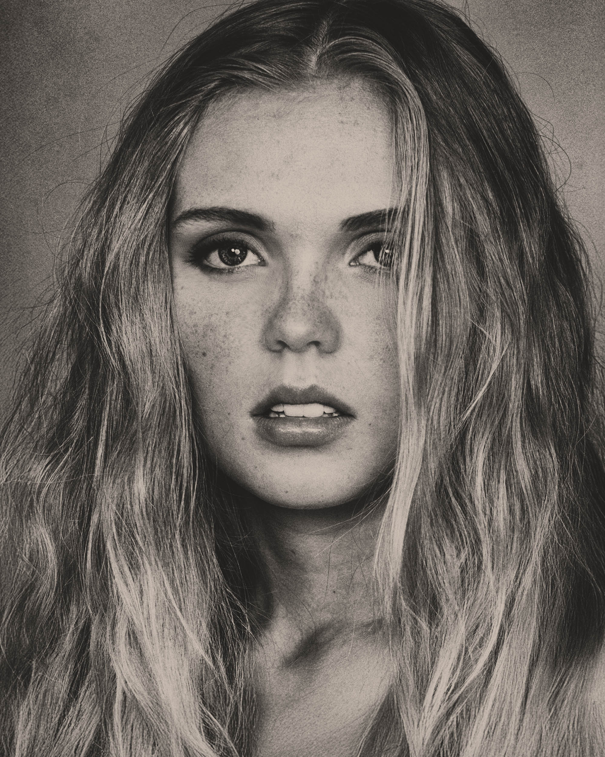 Simple, close up portrait of Olivia in overalls in the studio.