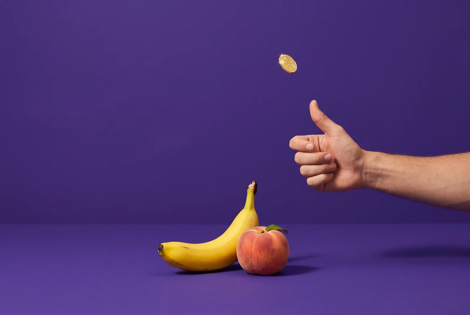 A hand flipping a gold coin above a banana and a peach, choosing between QUITTR vs Fortify