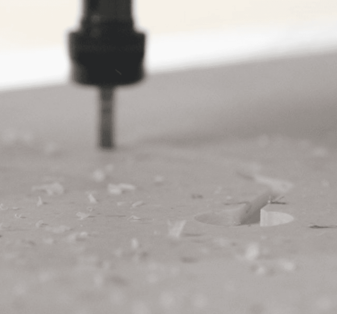Image of a CNC machine milling a recycled plastic sheet