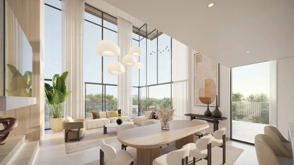 A modern living room in cilia featuring large windows and a dining table, creating a bright and inviting atmosphere.