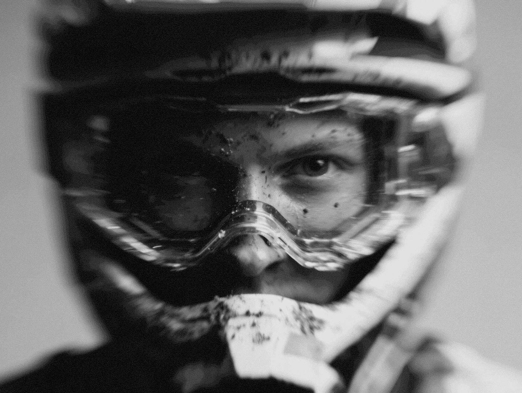 A helmeted rider in action with layered gear and intense forward momentum