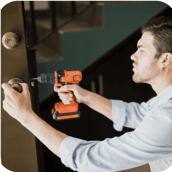 Craftsman measuring and aligning door components.