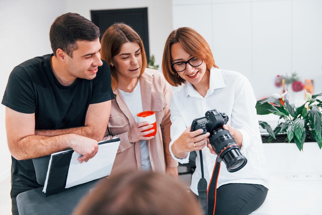 Wedding photographer showing photos to couple during consultation