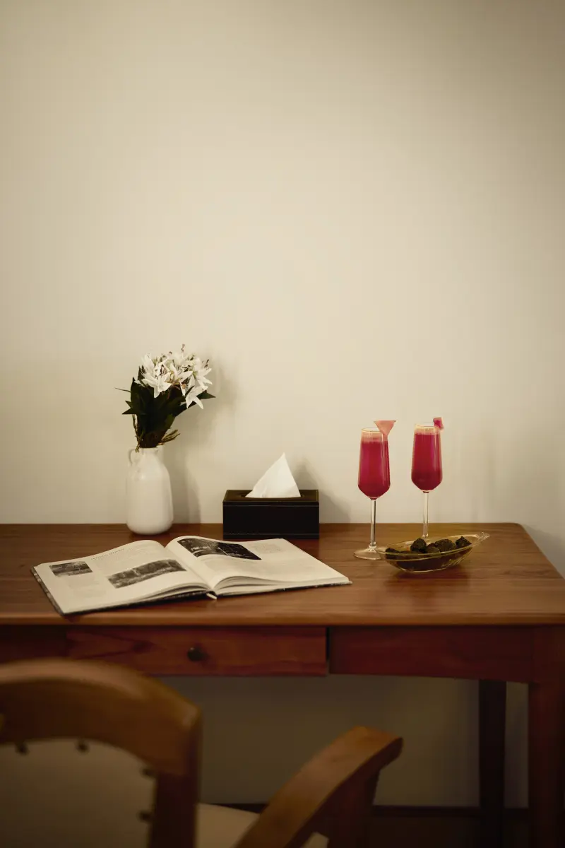 Writing table in a Lake View Room at Vedic Village Alleppey set with welcome drinks, fresh flowers and reading material
