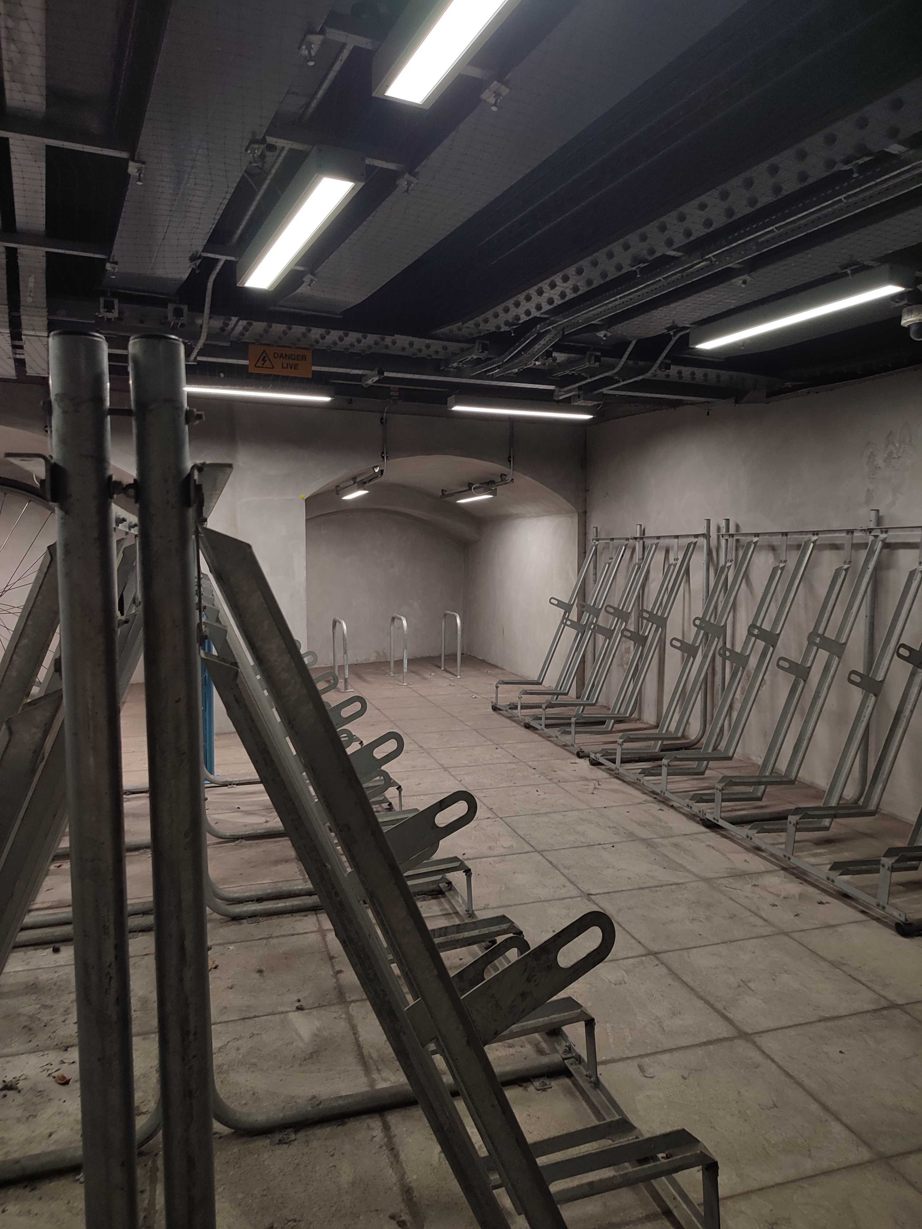 The inside of the London Bride Cycle Hub, showing a mix of semi vertical and sheffield stand bike racks