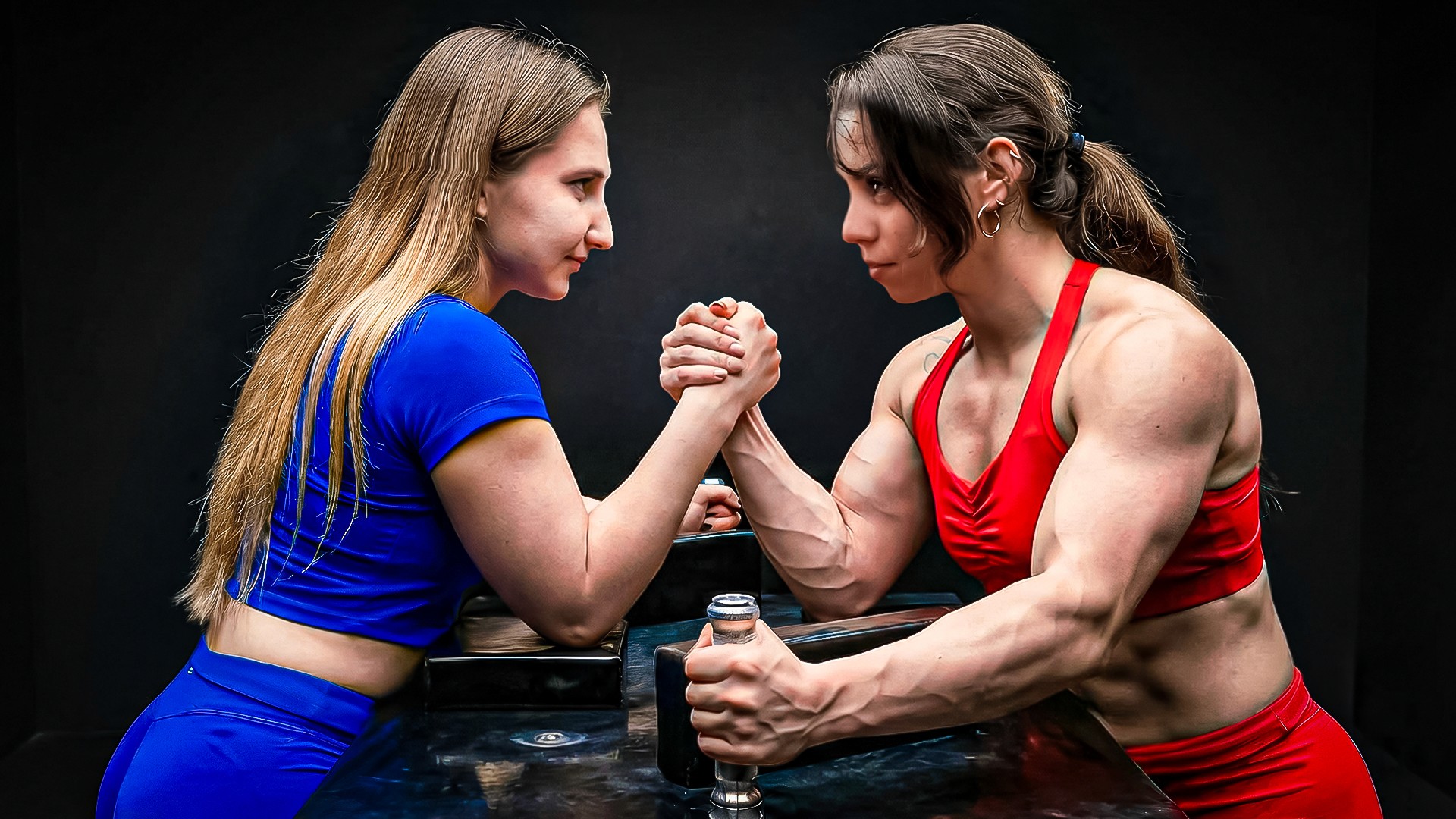 Competition YouTube thumbnail featuring two women arm wrestling in athletic gear — sports challenge thumbnail with face-off composition and high tension