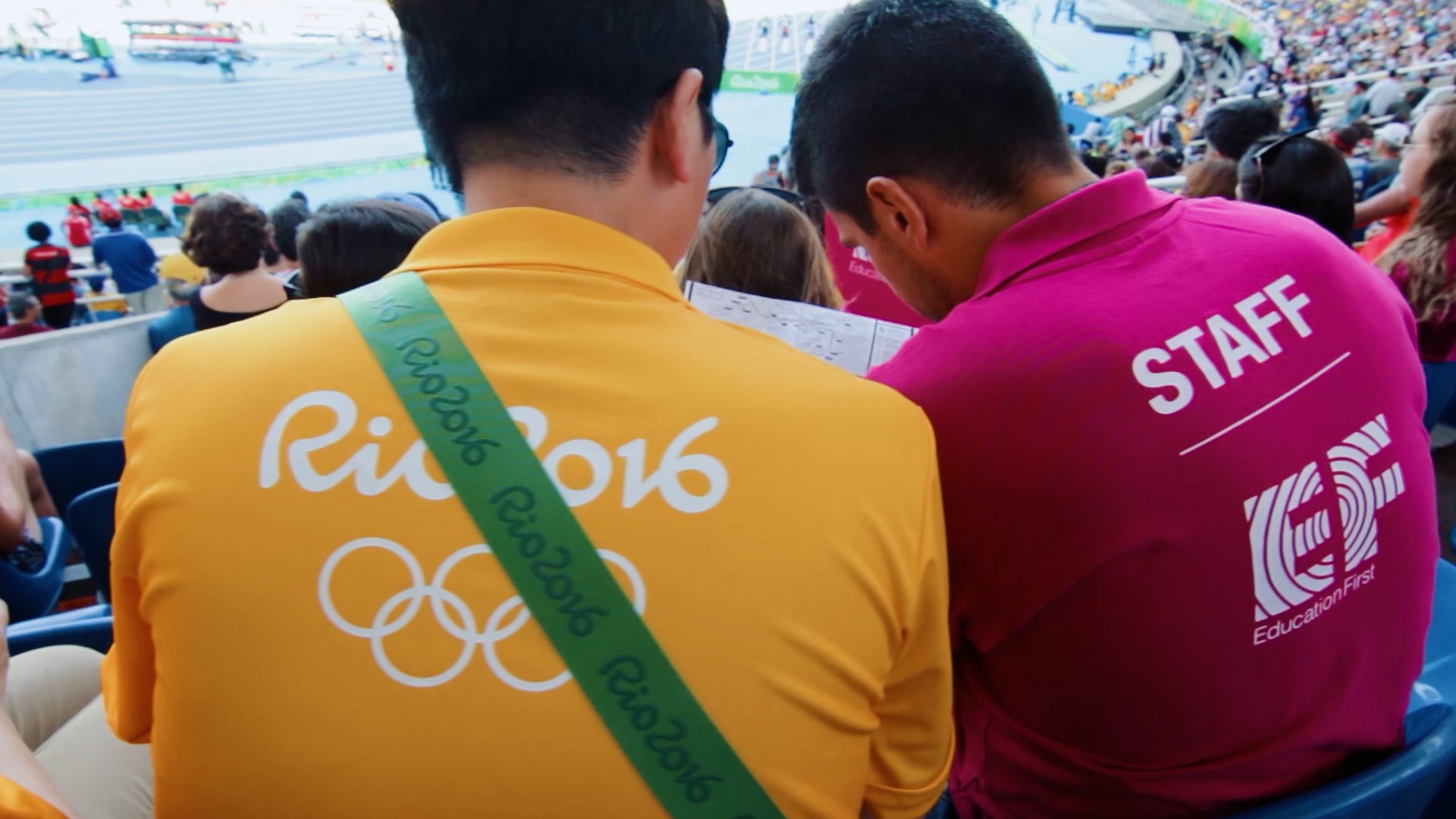 Institutional film of Education First staff team watching a race in the stadium during the EF Youth Leadership Forum