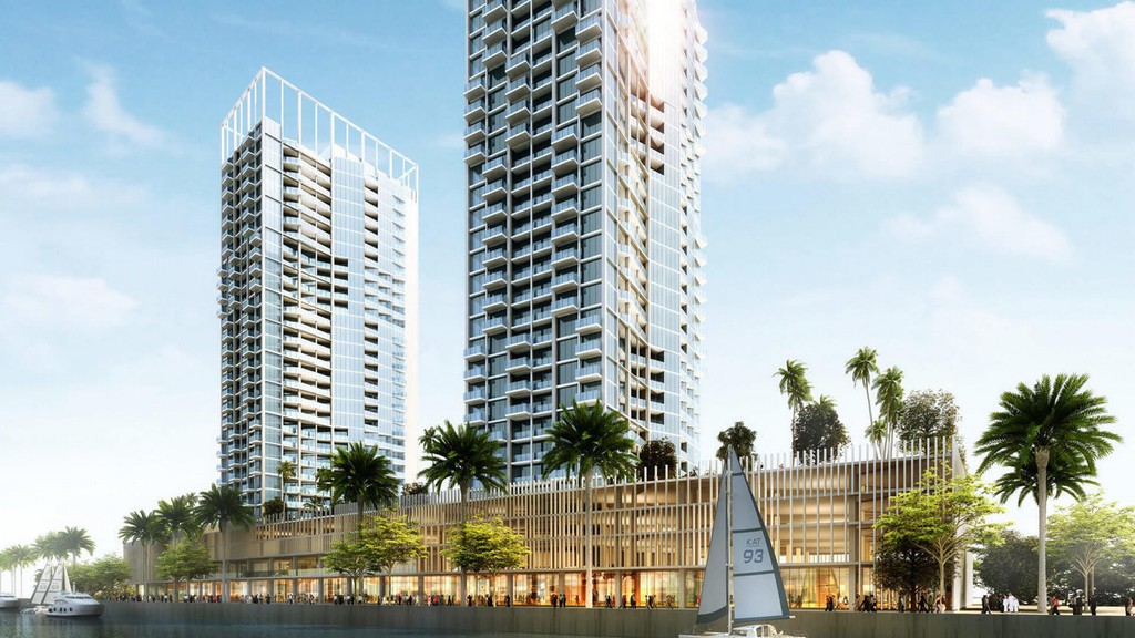 Exterior view of Damac Maison Prive, a luxury hotel featuring modern architecture and scenic waterfront surroundings.
