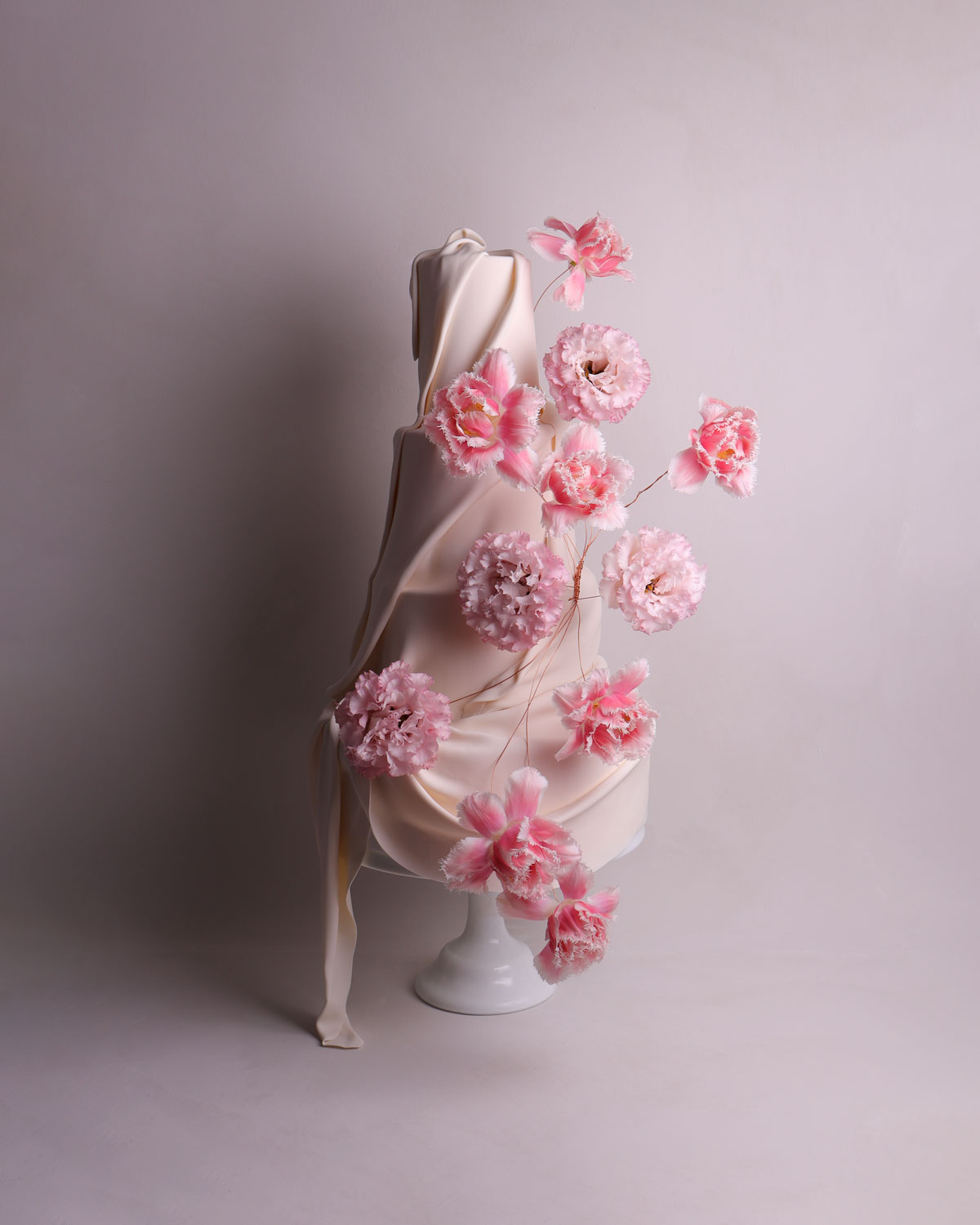 four tier wedding cake, minimalist in design with custom angled features. 