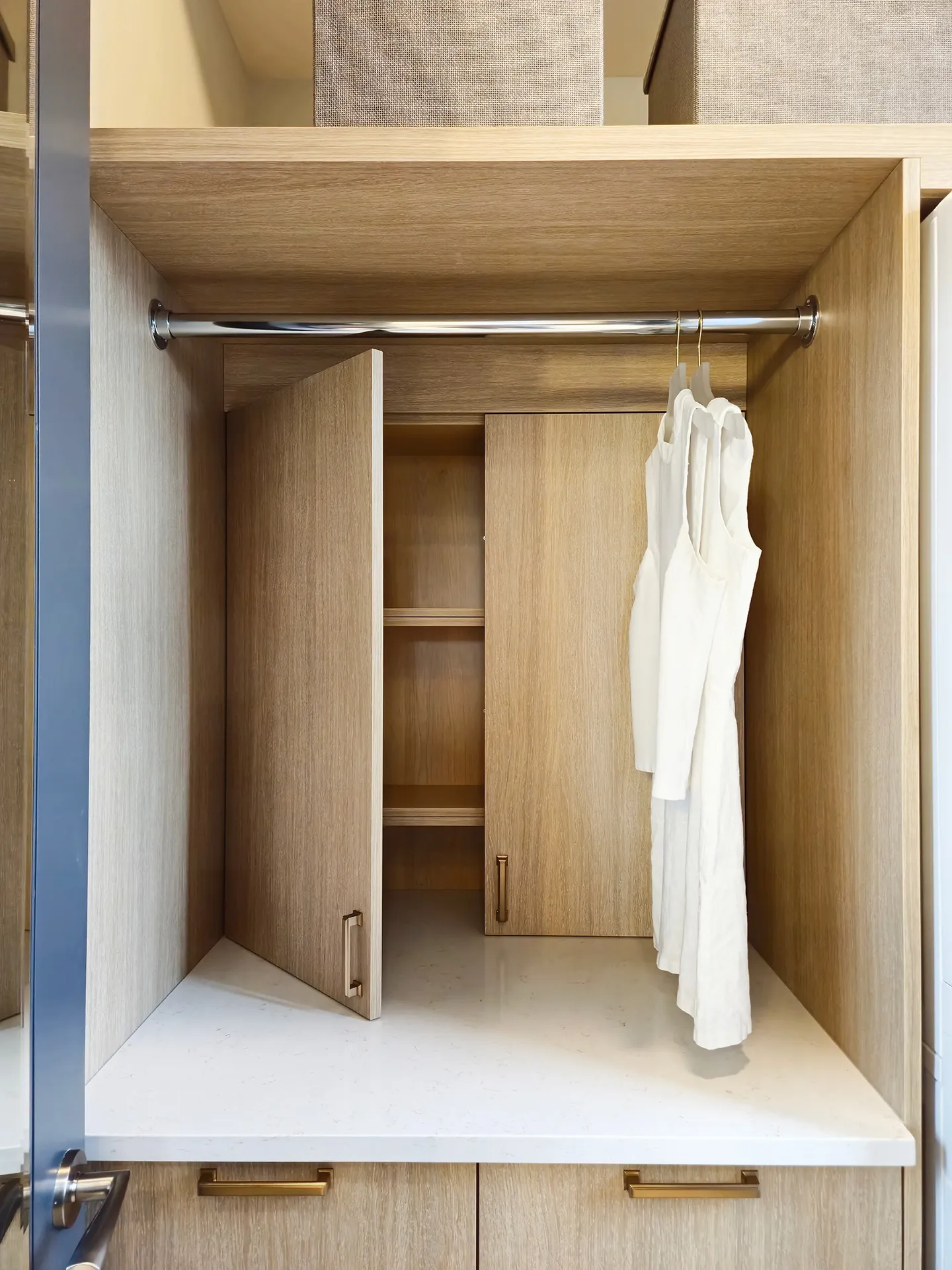 Image of light woodwork and a laundry rod holding a white shirt.