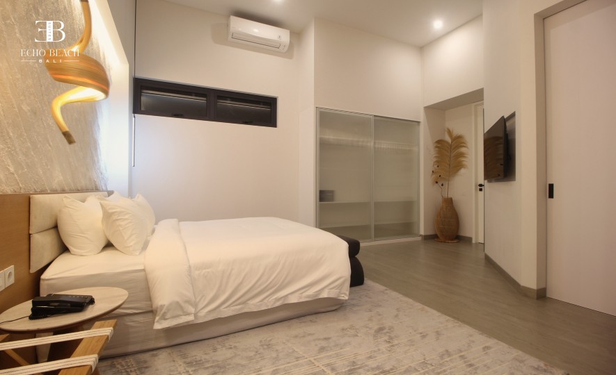 Luxurious three bathroom ensuite in a Canggu Bali apartment at Echo Beach Suite, showcasing a walk-in rain shower and modern vanity.