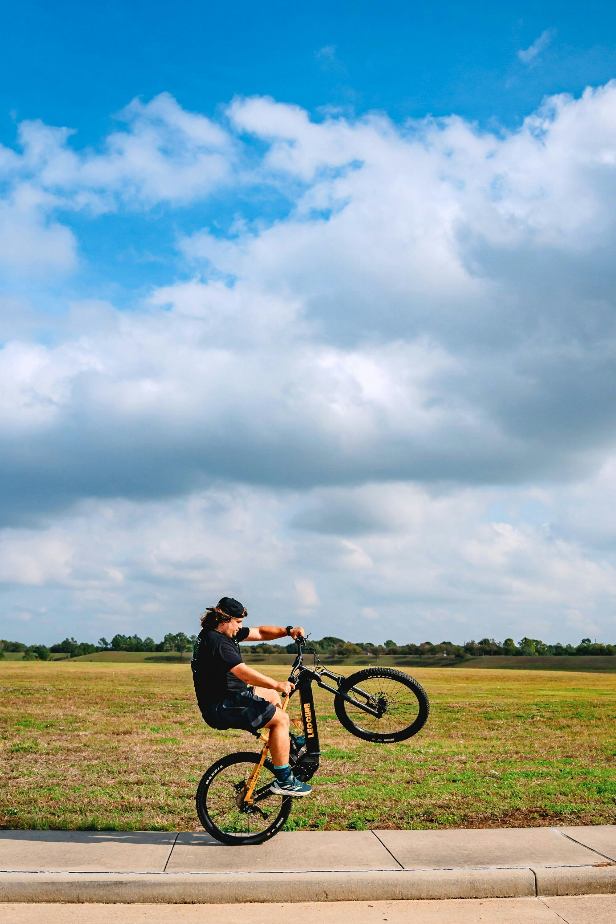 A man on a bike doing a trick in the air