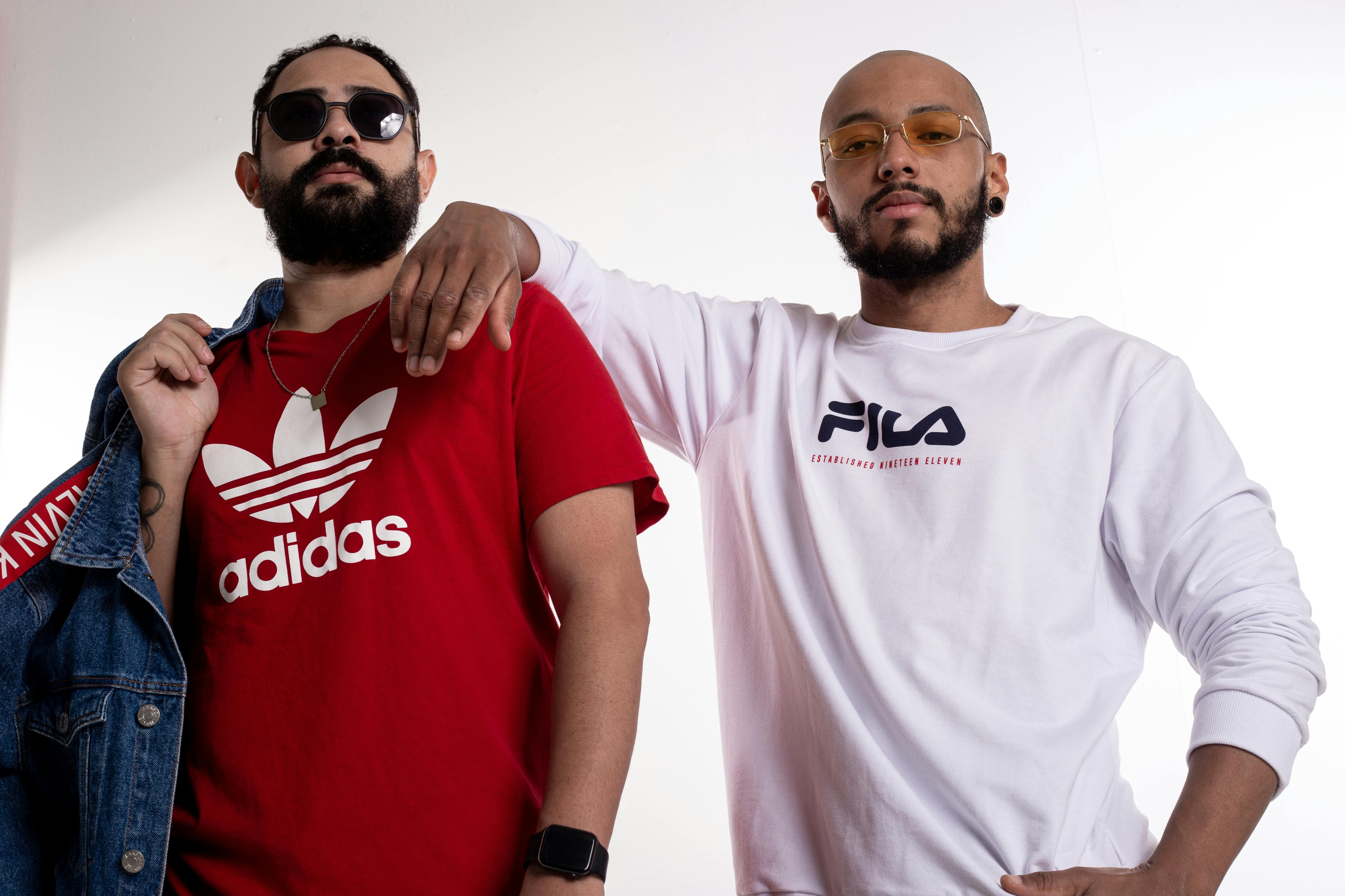 two-men-in-contemporary-fashion-with-branded-apparel,-posing-confidently-against - guto-macedo (pexels)