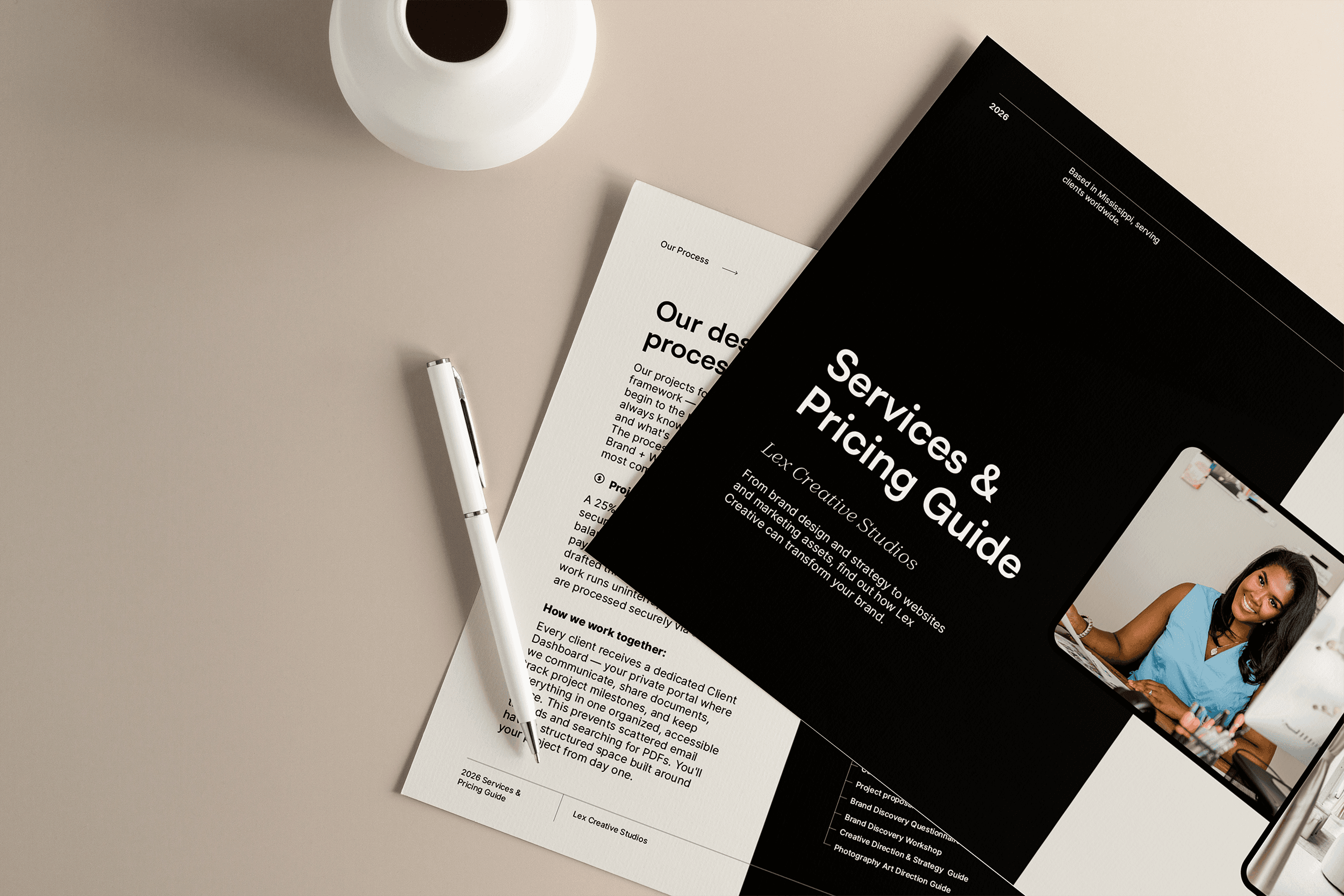 A group of six people poses on a city street, with buildings and shops visible in the background.