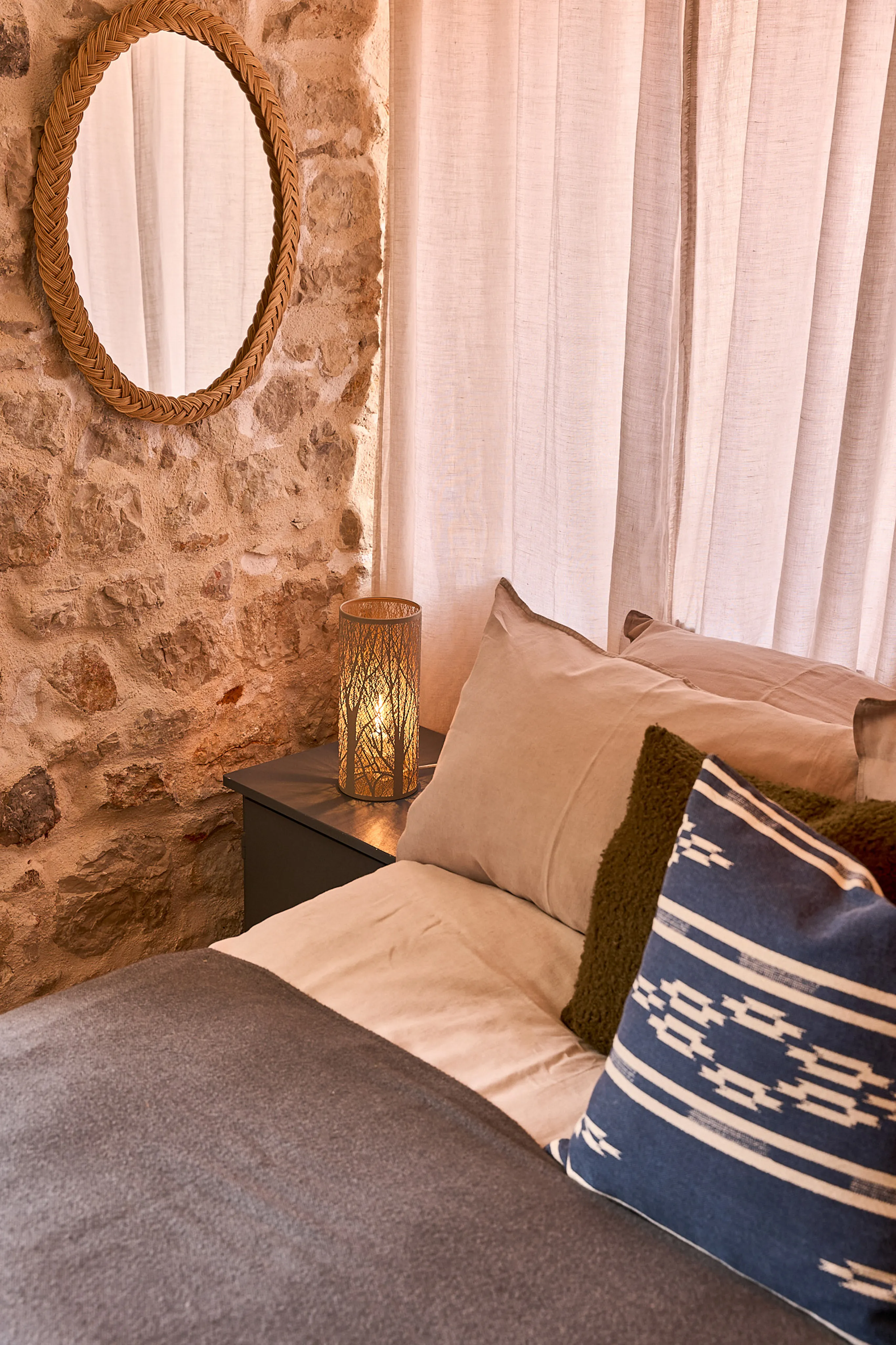  King bed headboard with round rope mirror against original stone wall, Silvija Suite, Hidden House Hvar
