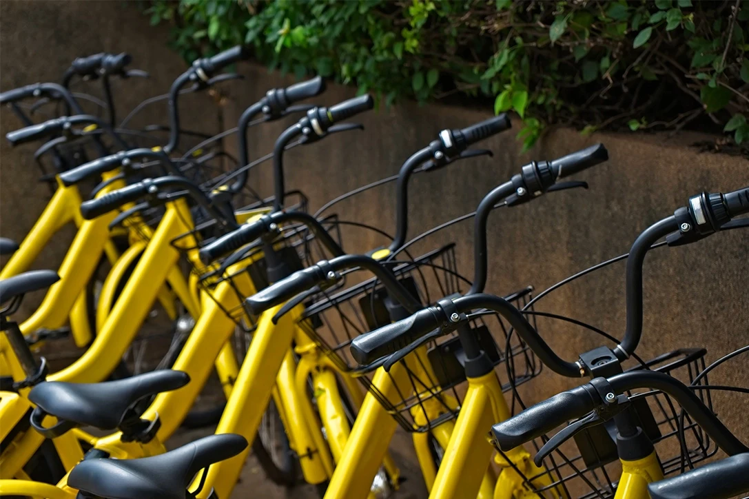 Shared rental bicycles parked in a docking station in downtown area