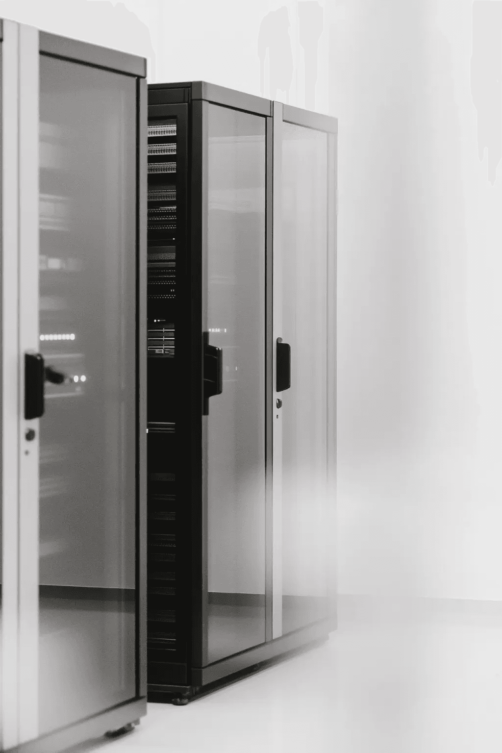 Server racks in a modern data center with reflective glass panels.