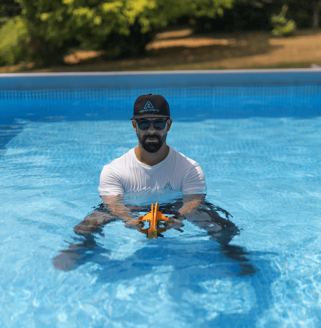 Man in pool pulling both Aqua-Bend discs side to side for oblique core exercise
