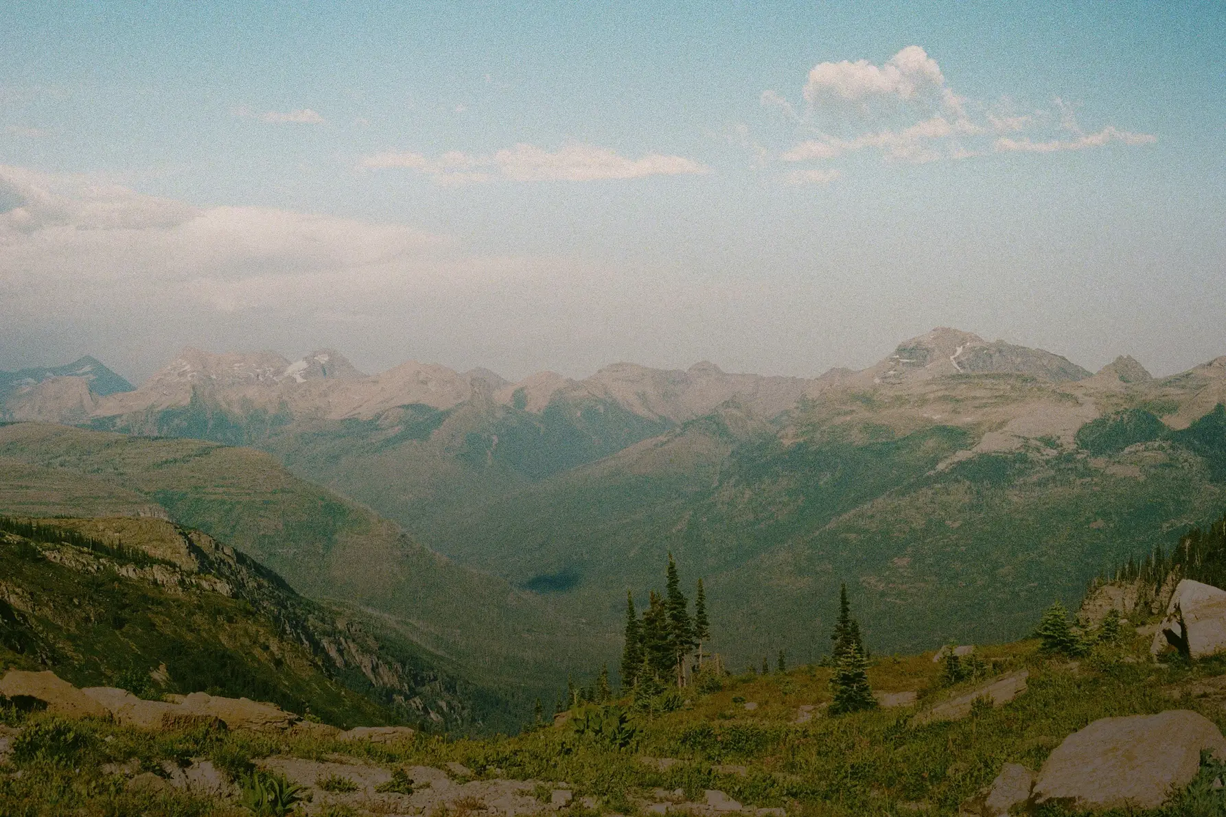A landscape image on the mountains with a tent near a lake
