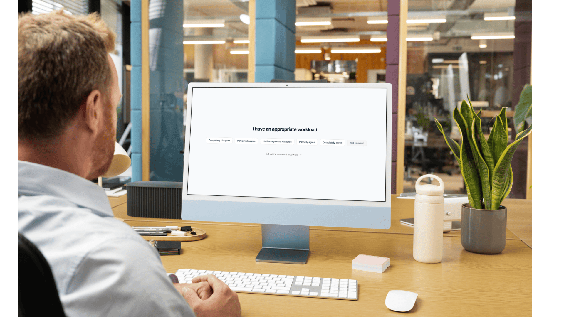 HR professional analyzing employee culture data on desktop computer