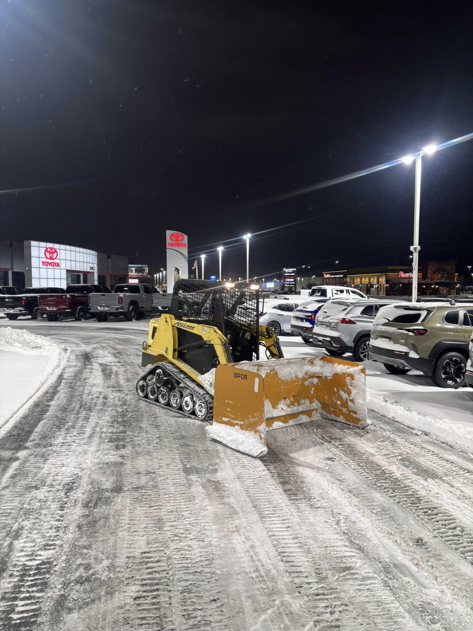 yellow excavator on gray concrete road during daytime