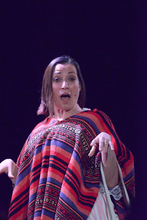 A Frow Show performer in a striped poncho mid-line