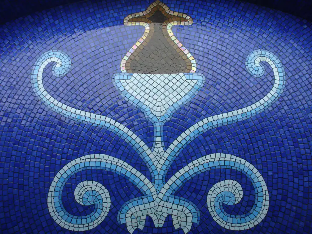 The mosaic being installed in the pool shell — Mosaiclegs Art Studio