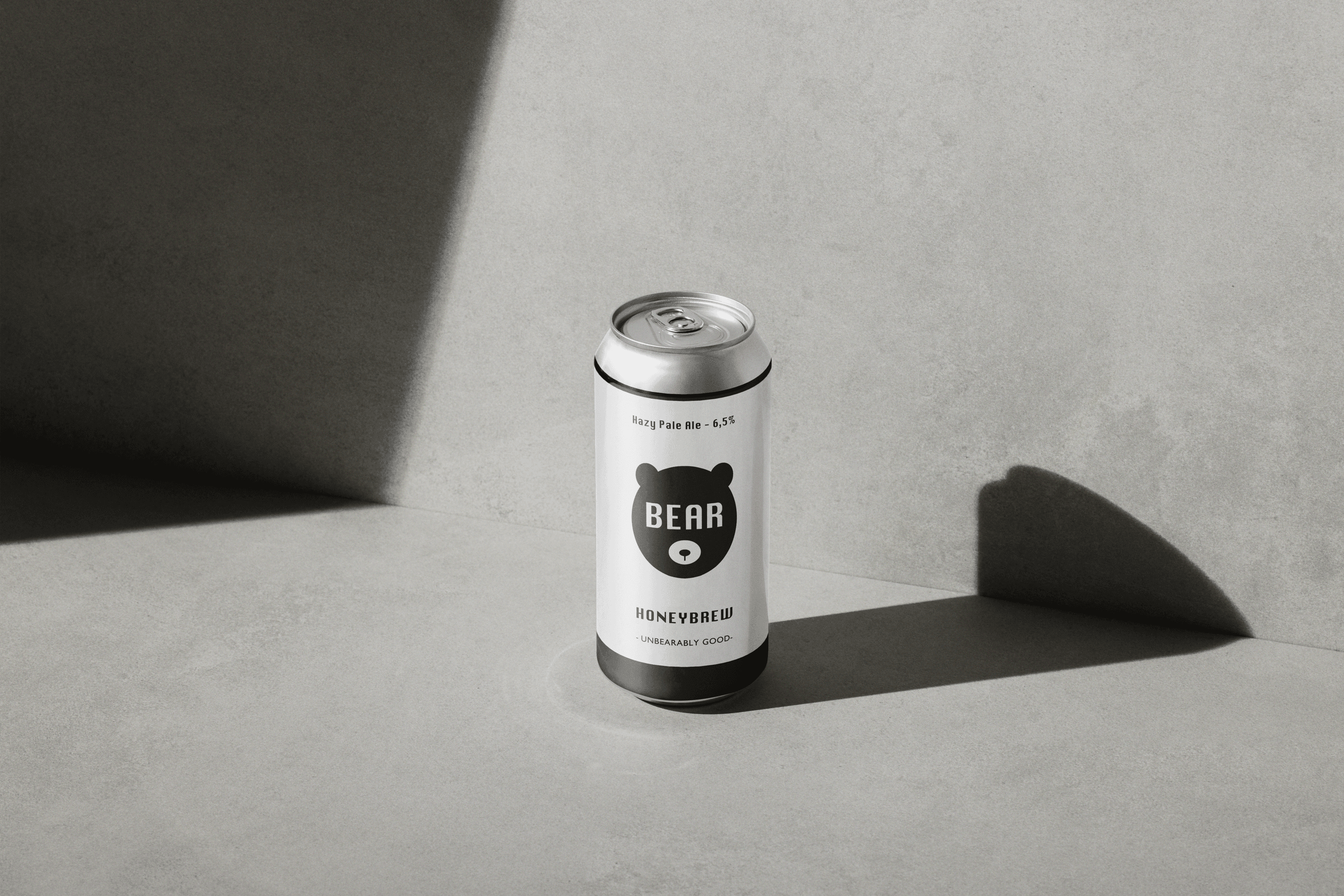  A can of Hazy Pale Ale, 6,5%, a cloudy and fruity beer style, called BEAR Honeybrew. The can features a bear logo and the text 'Unbearably Good.