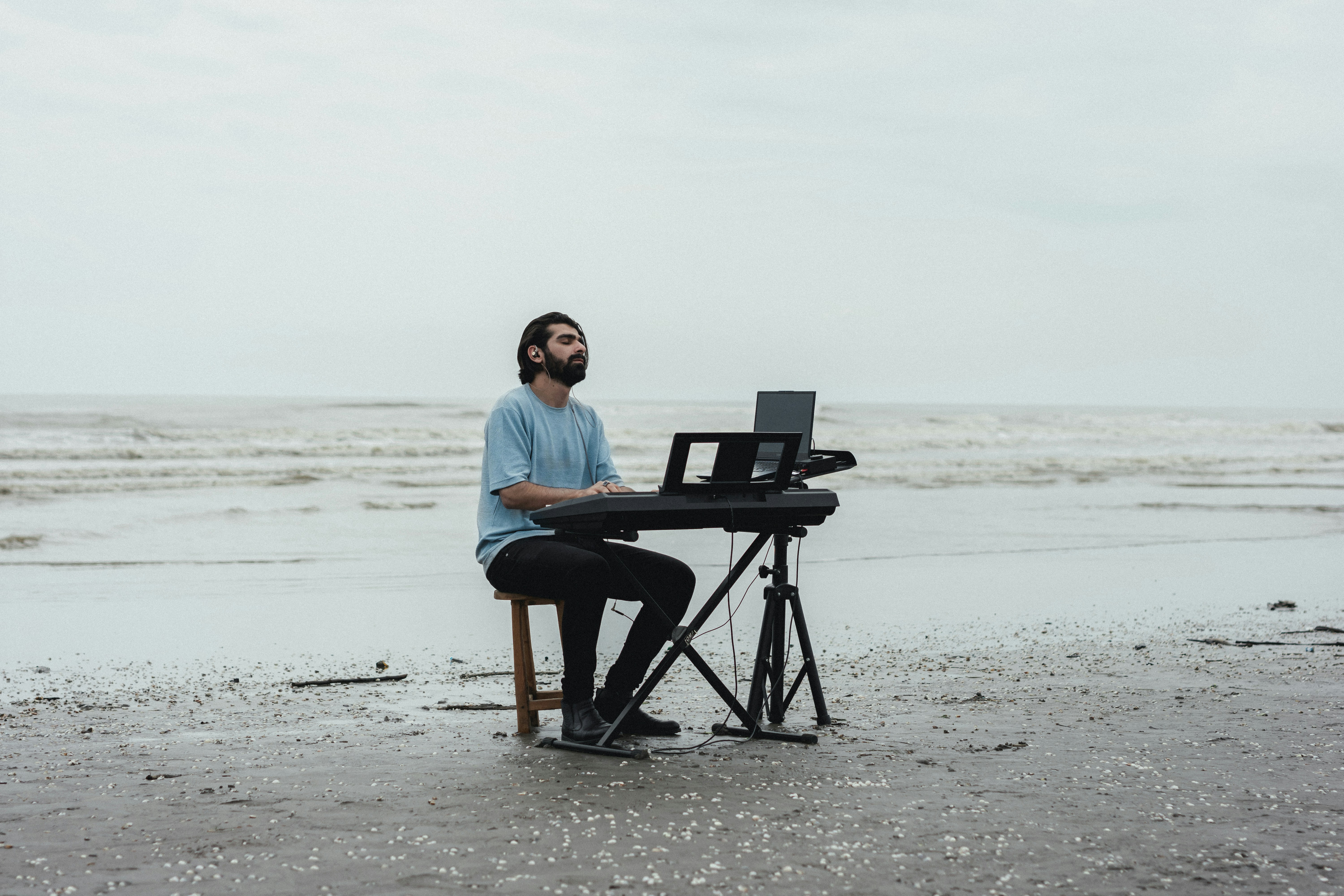A man sitting at a desk on the beach