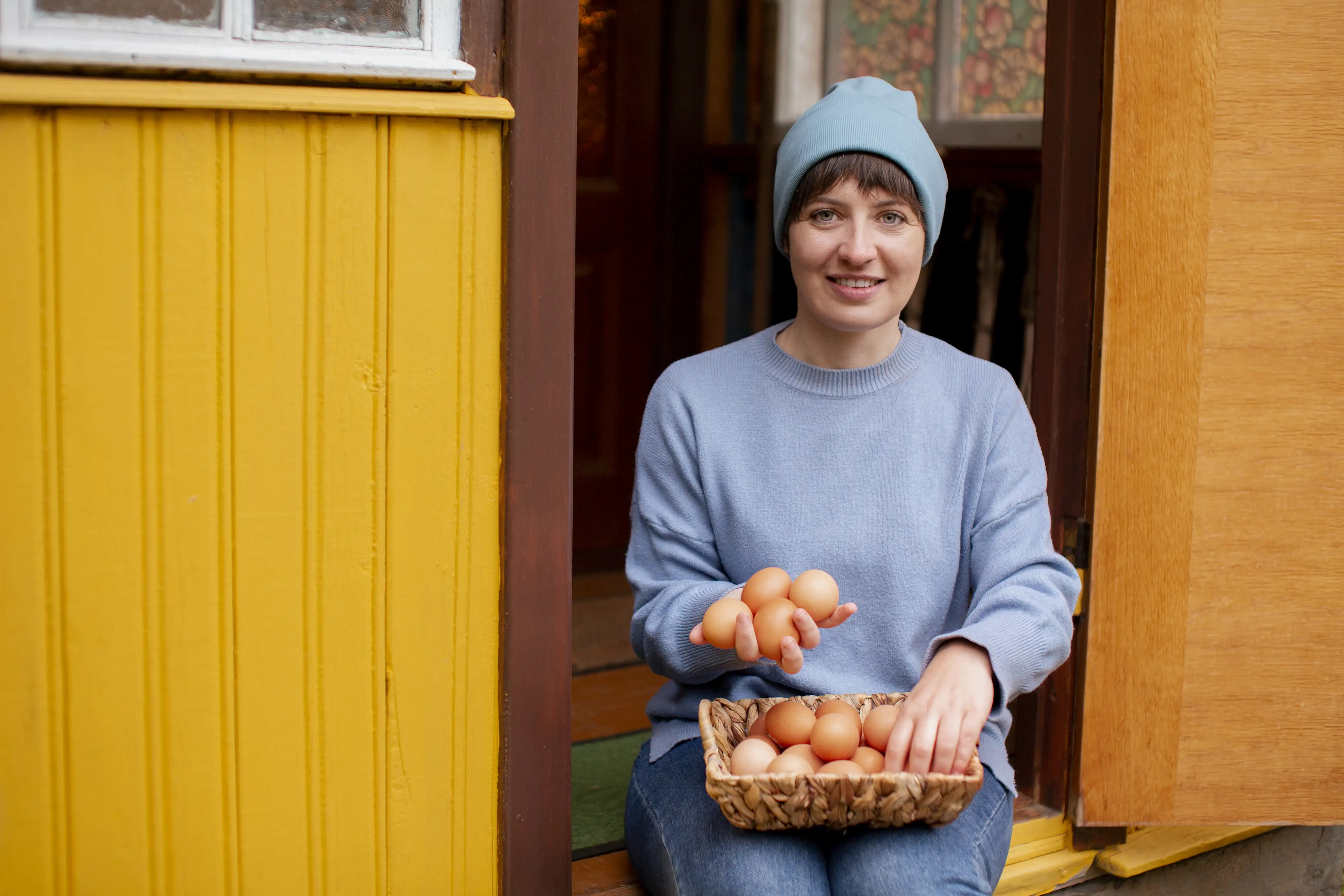 A brown cow standing on top of a lush green field