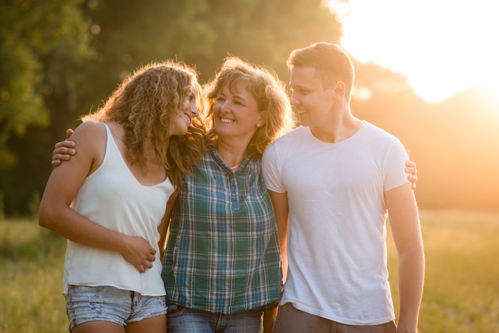 Happy family walking in a sunlit park