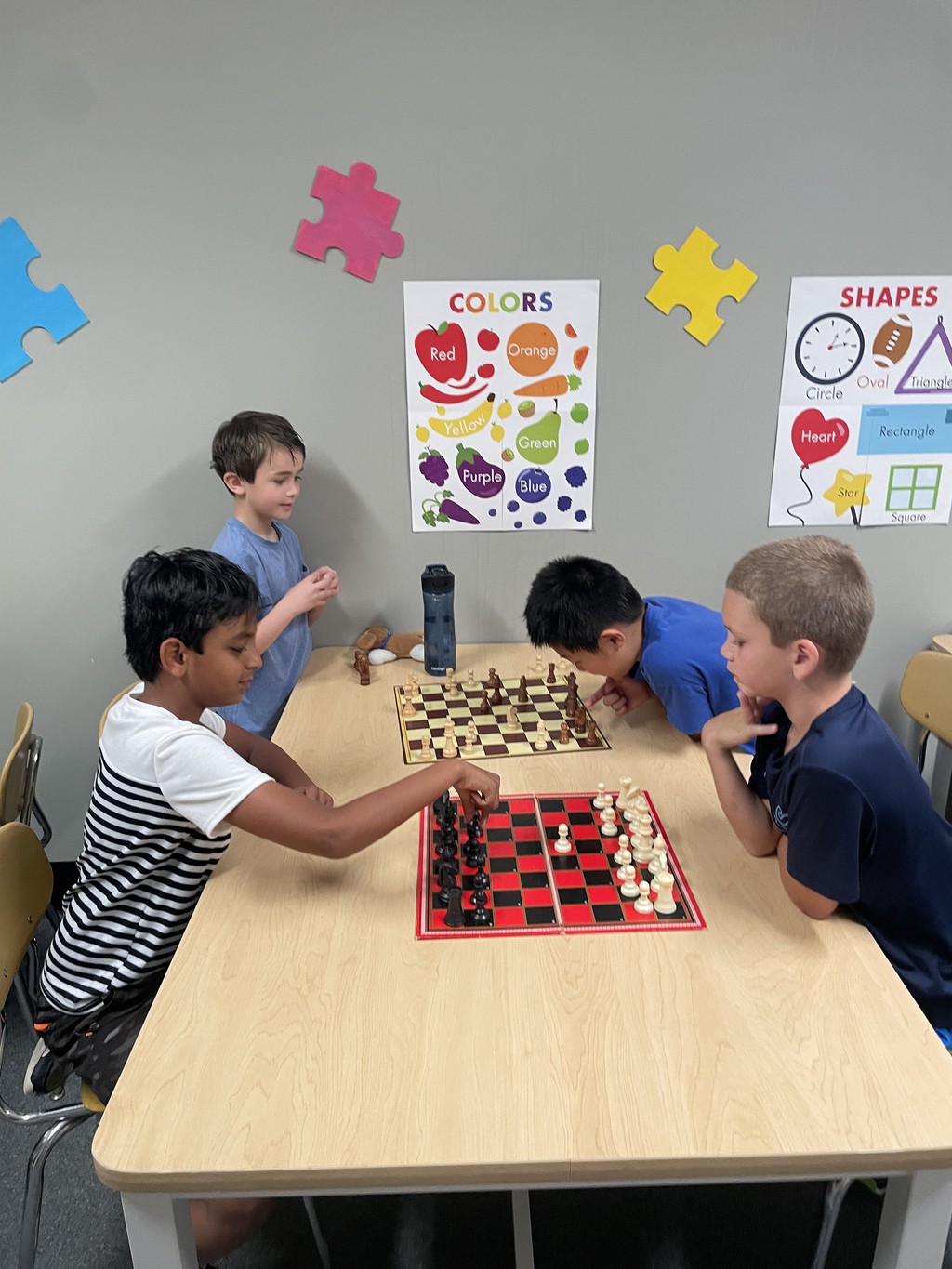 SportPlus Charlotte chess class with four boys playing chess against each other in our learning room 