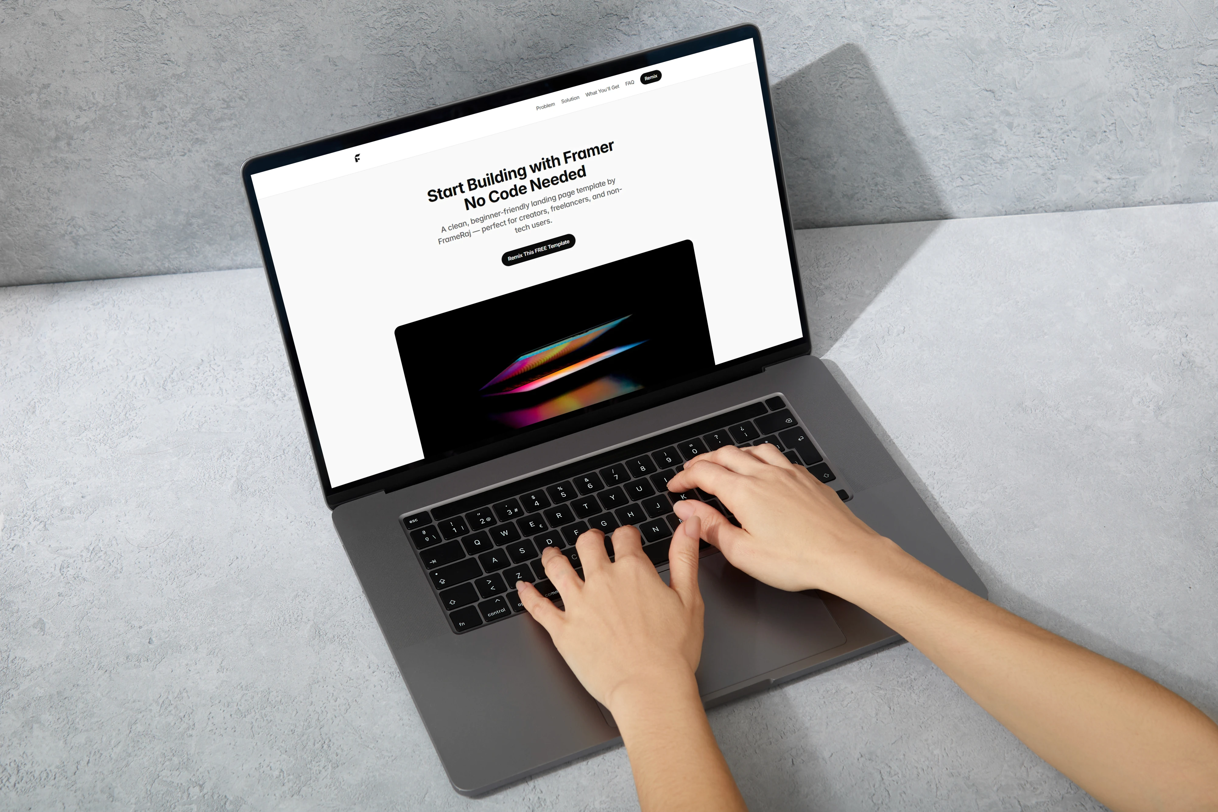 Hands typing on a laptop displaying a Framer landing page template titled 'Start Building with Framer'.