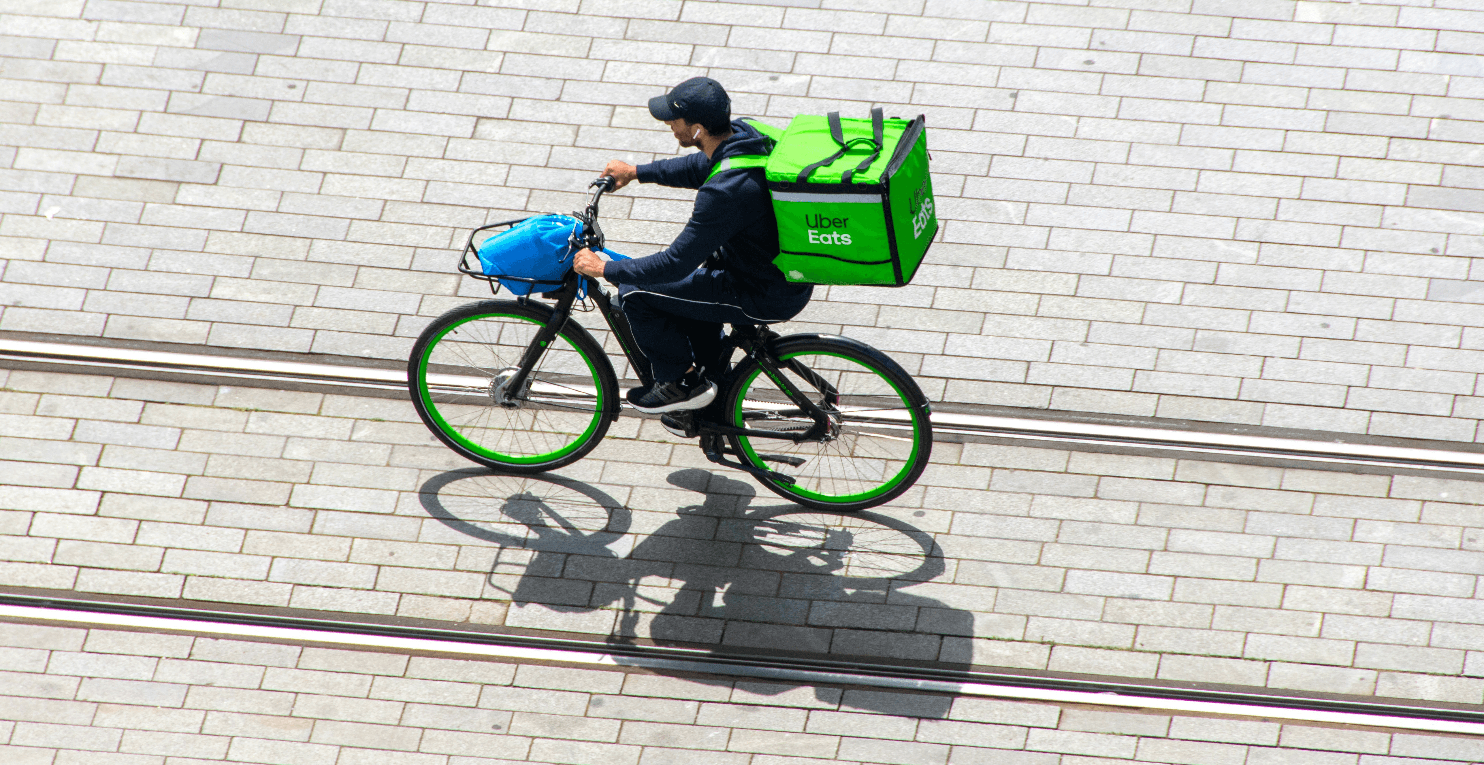 a man riding a bike down a street