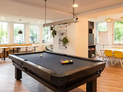 Games room in student accommodation in Darmstadt with pool table and social seating