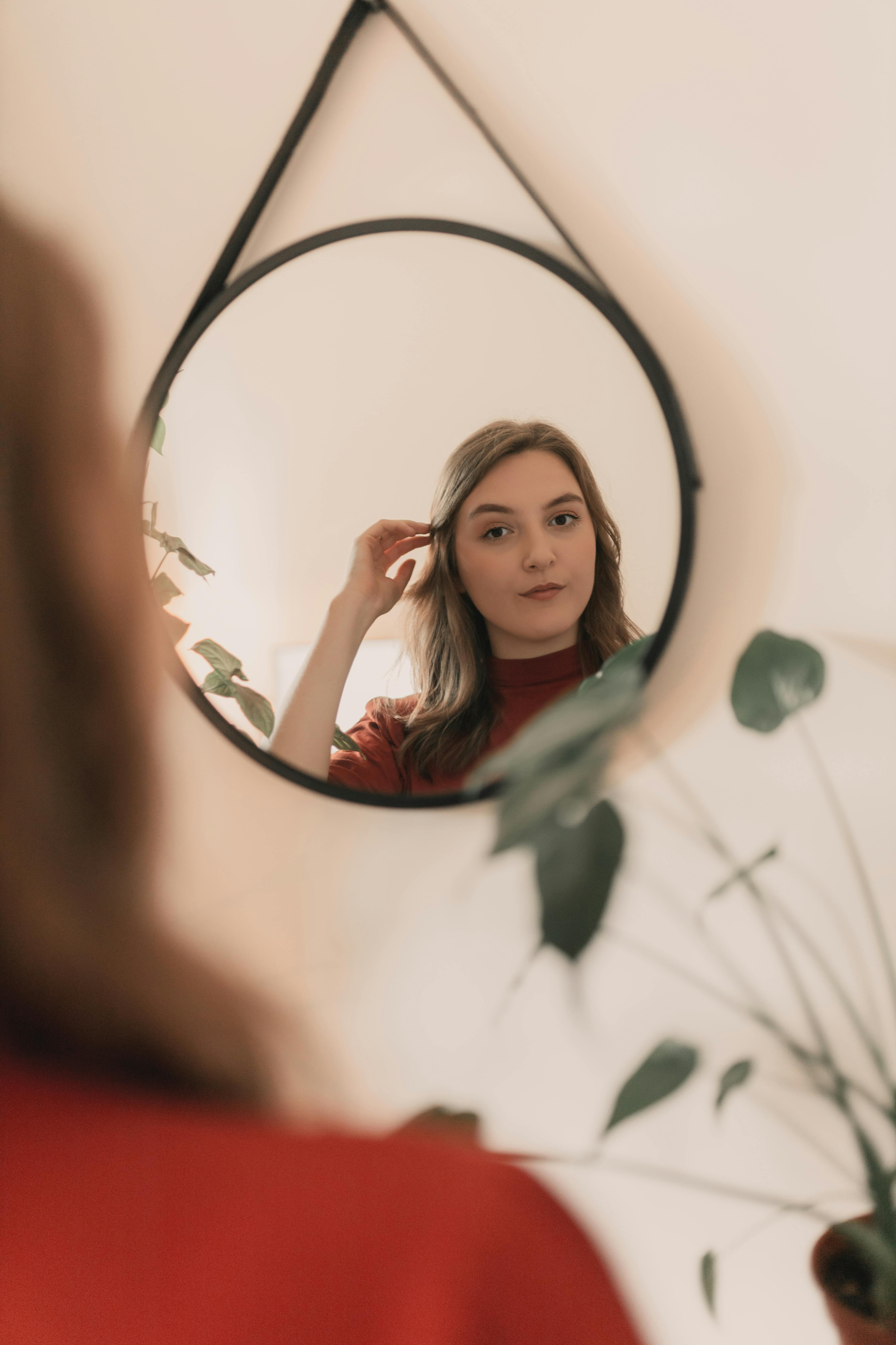 Woman looking at herself in mirror