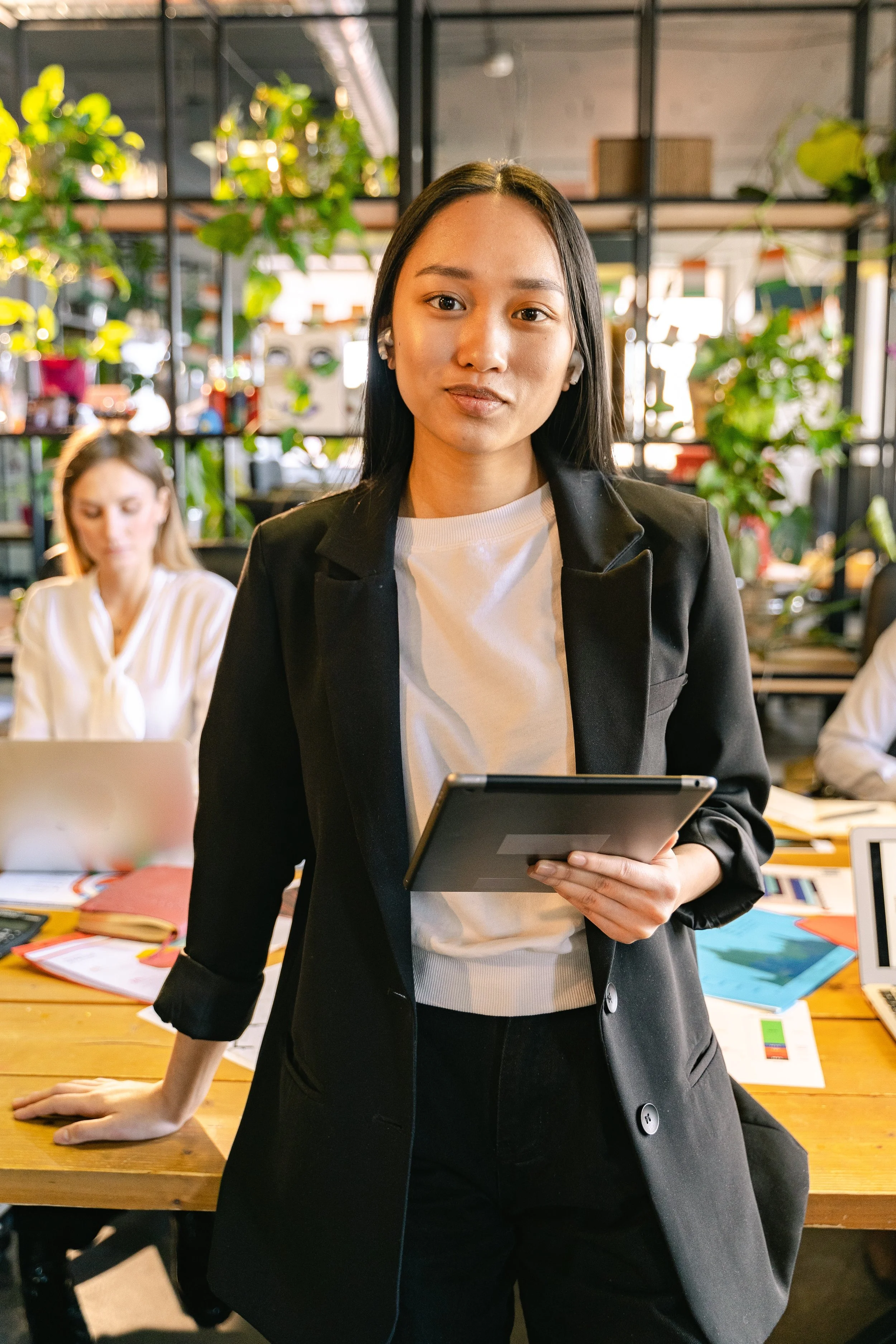 A woman leader sits at an office desk