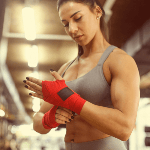 female fighter putting on hand wraps