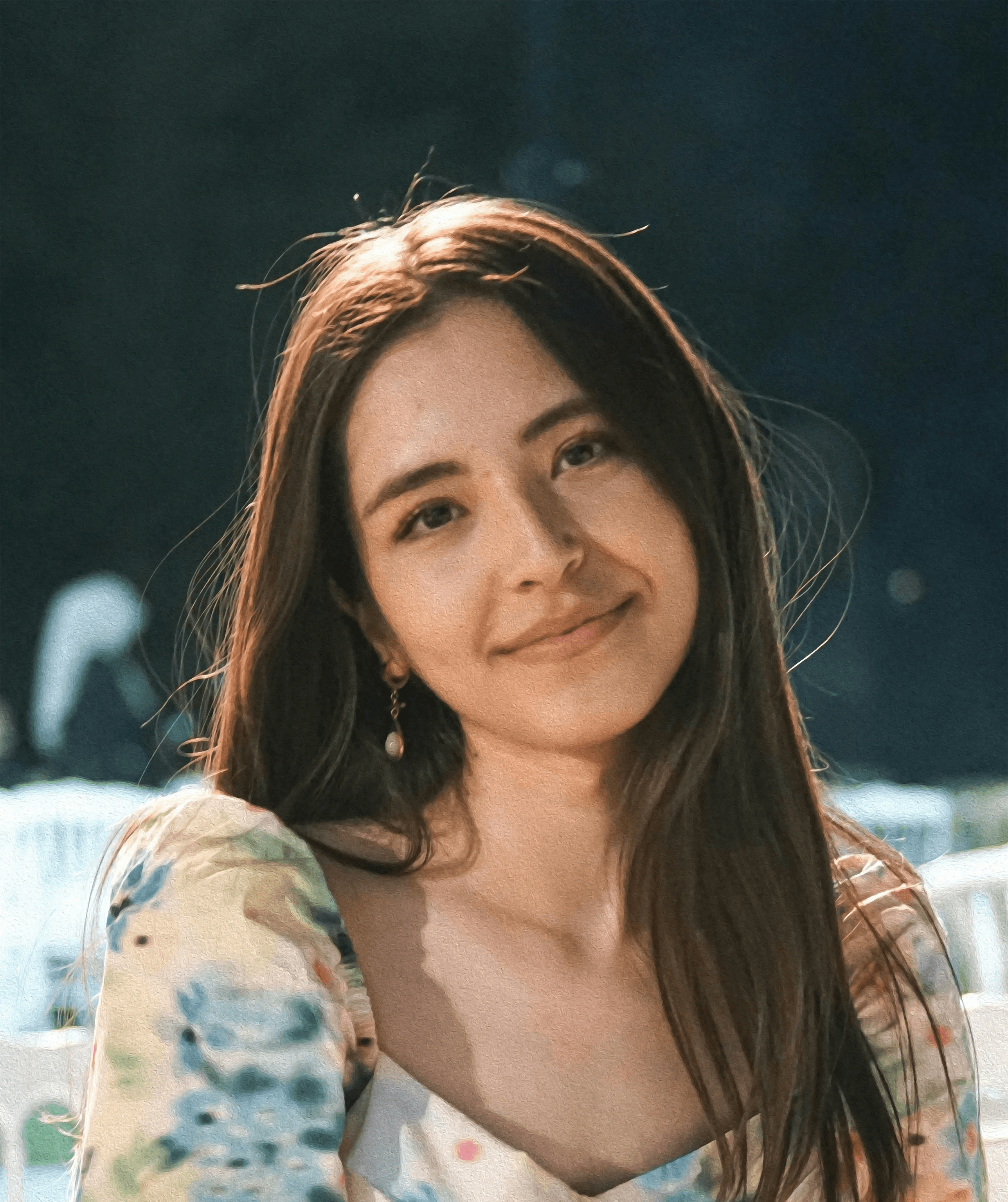 a woman sitting on a white chair next to a table