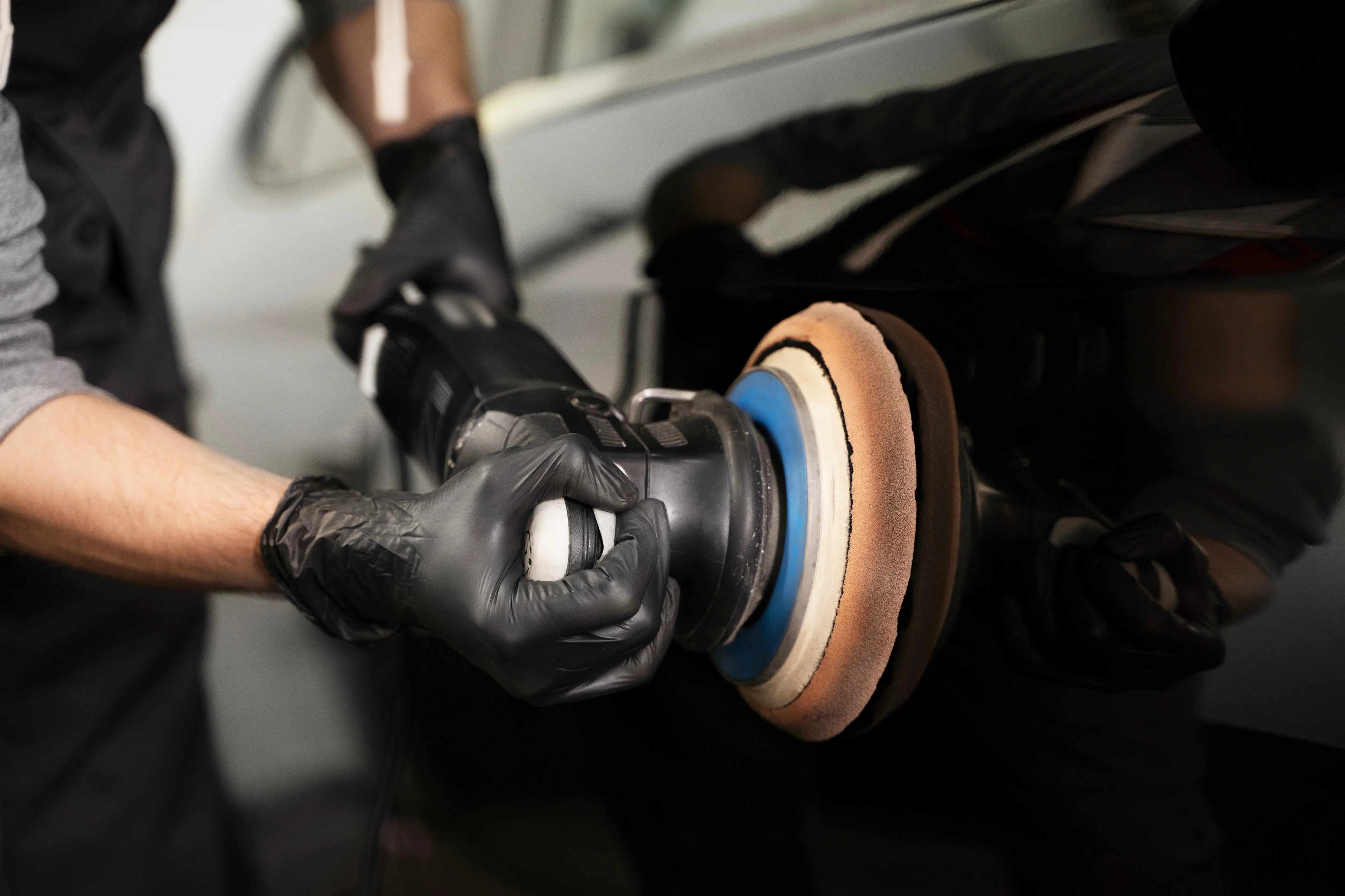 Paint correction process of a black car in.