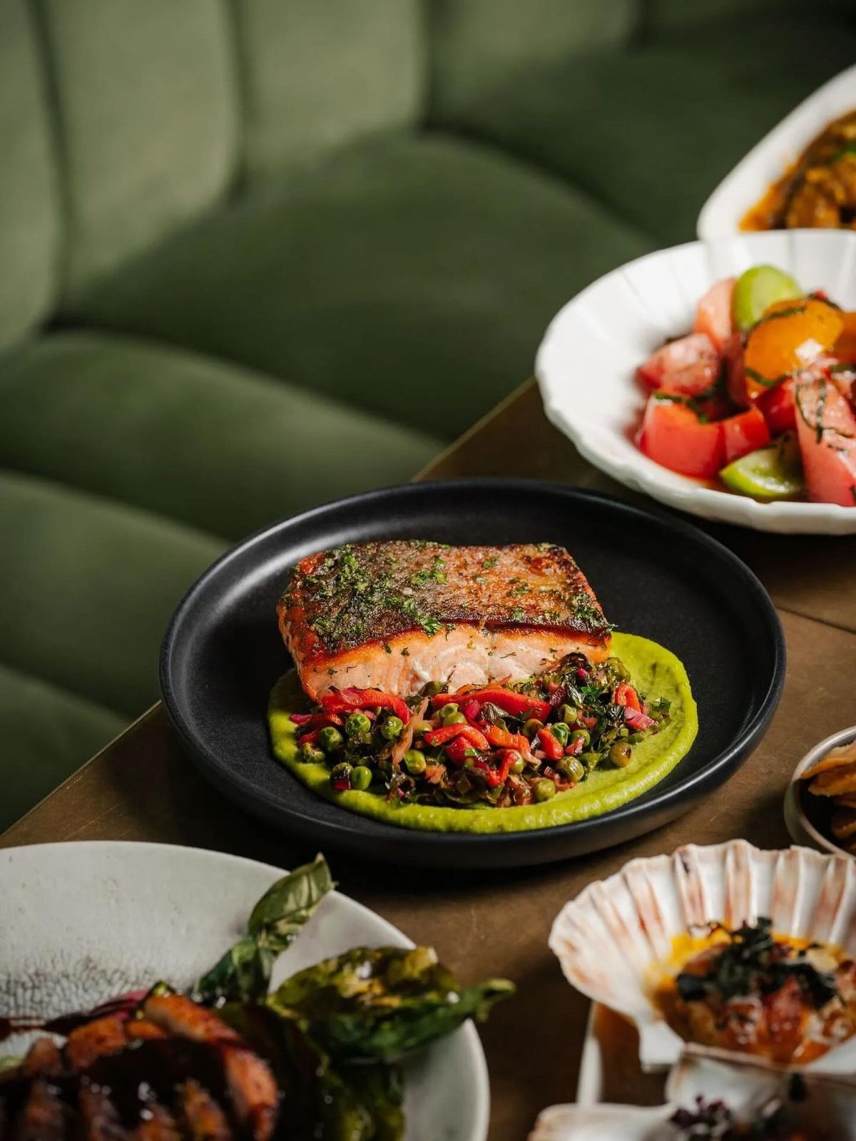 Pan-seared salmon paired with colorful farm vegetables, reflecting Dhoom’s ingredient-driven philosophy and dedication to clean, honest Indian flavors.