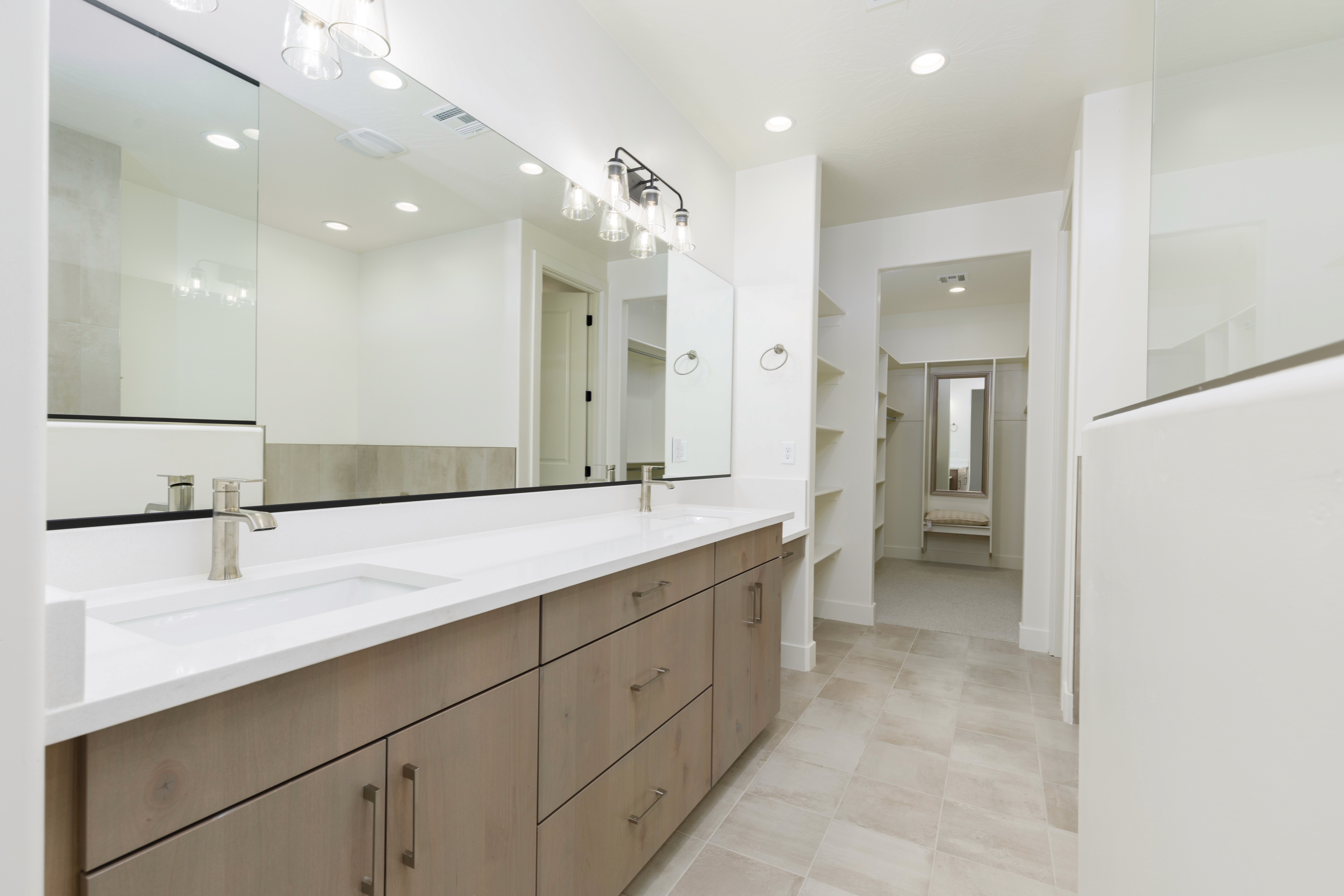 Bathroom in a Hurricane Utah custom home featuring flat-panel cabinets, showcasing clean, modern lines and functional storage.
