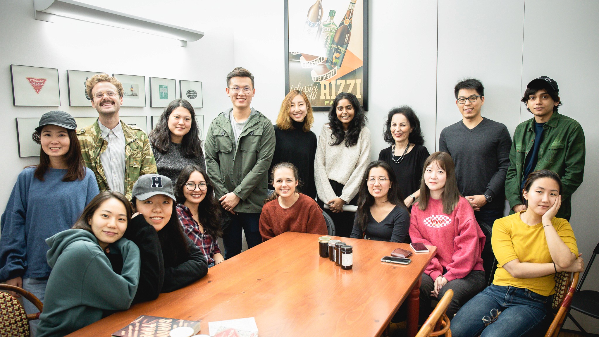 students pose with Louise Fili in her studio