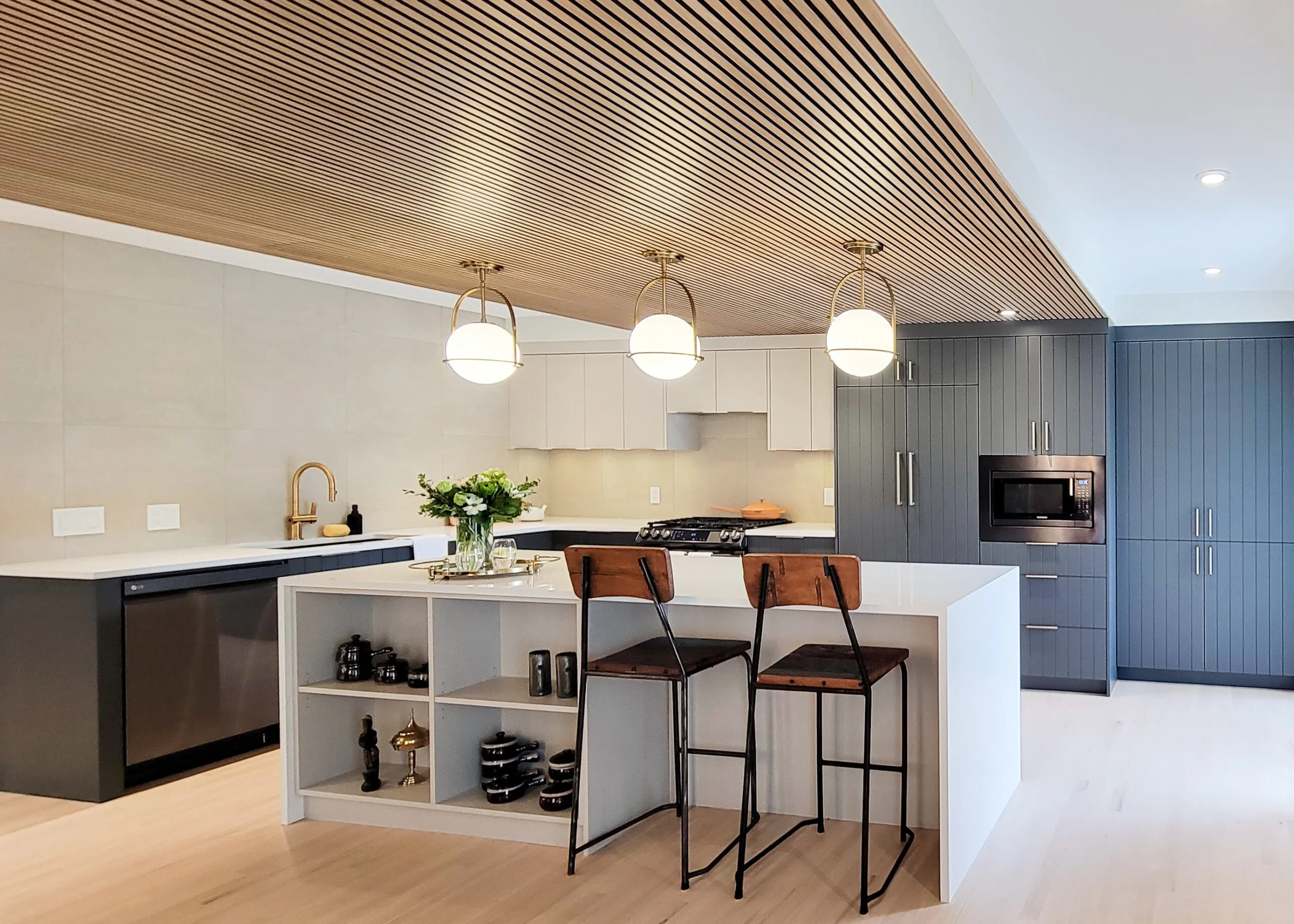Image of blue and light kitchen with full wall of tile walls.