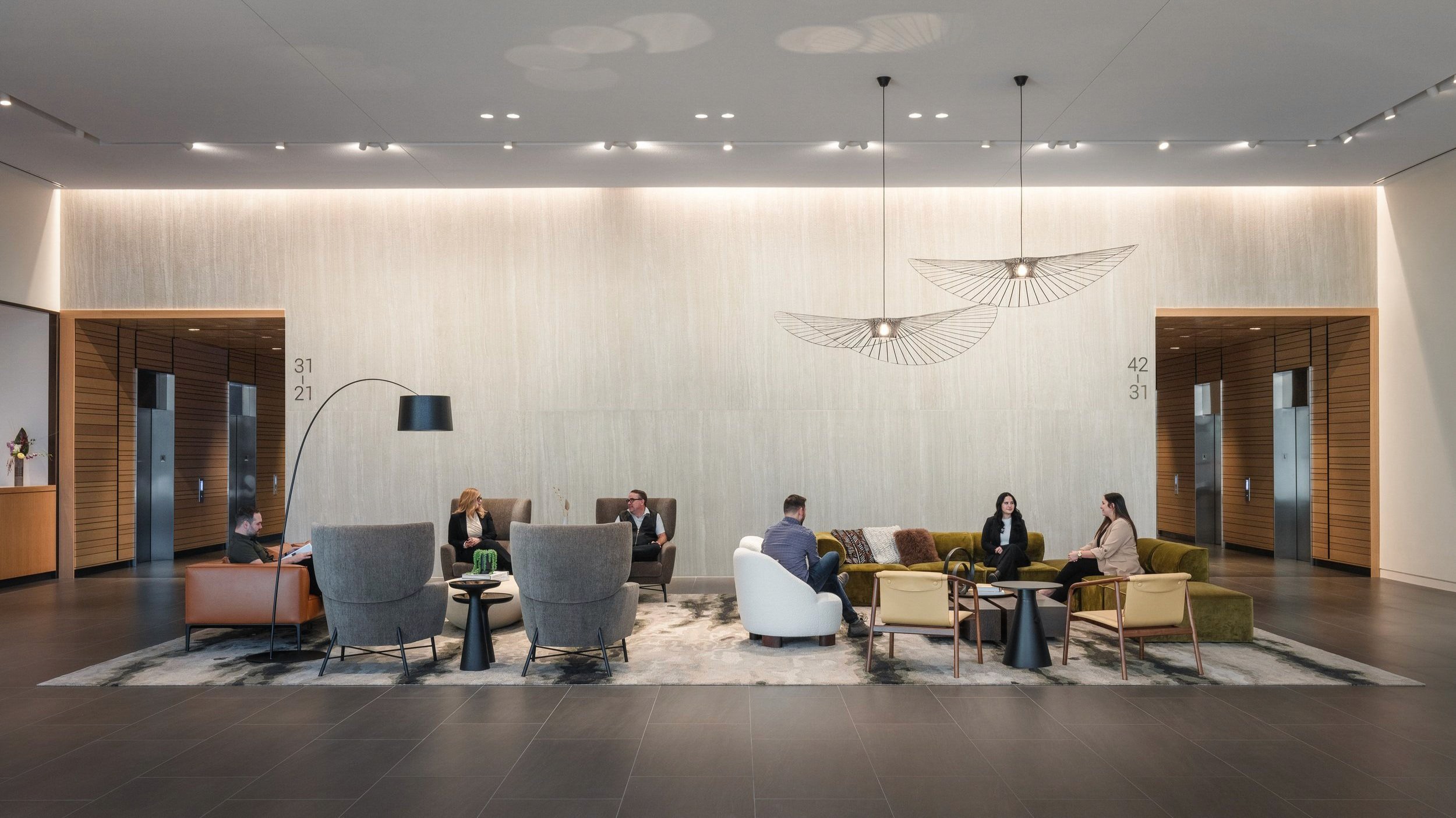 Lobby with people seated in chairs and on sofa